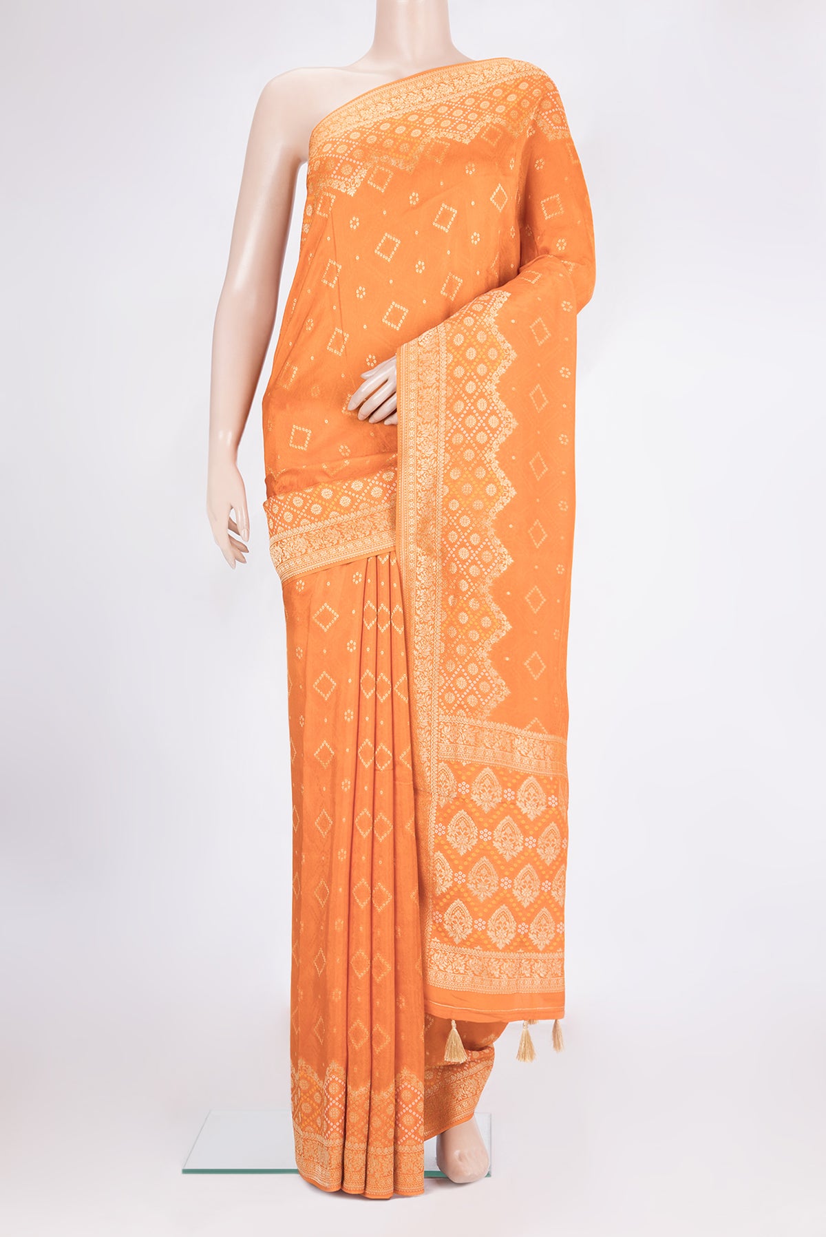 Orange Dual Tone Blended Banarasi Silk Saree with Bandhani Print on the body and Zari Border.  displayed on a mannequin