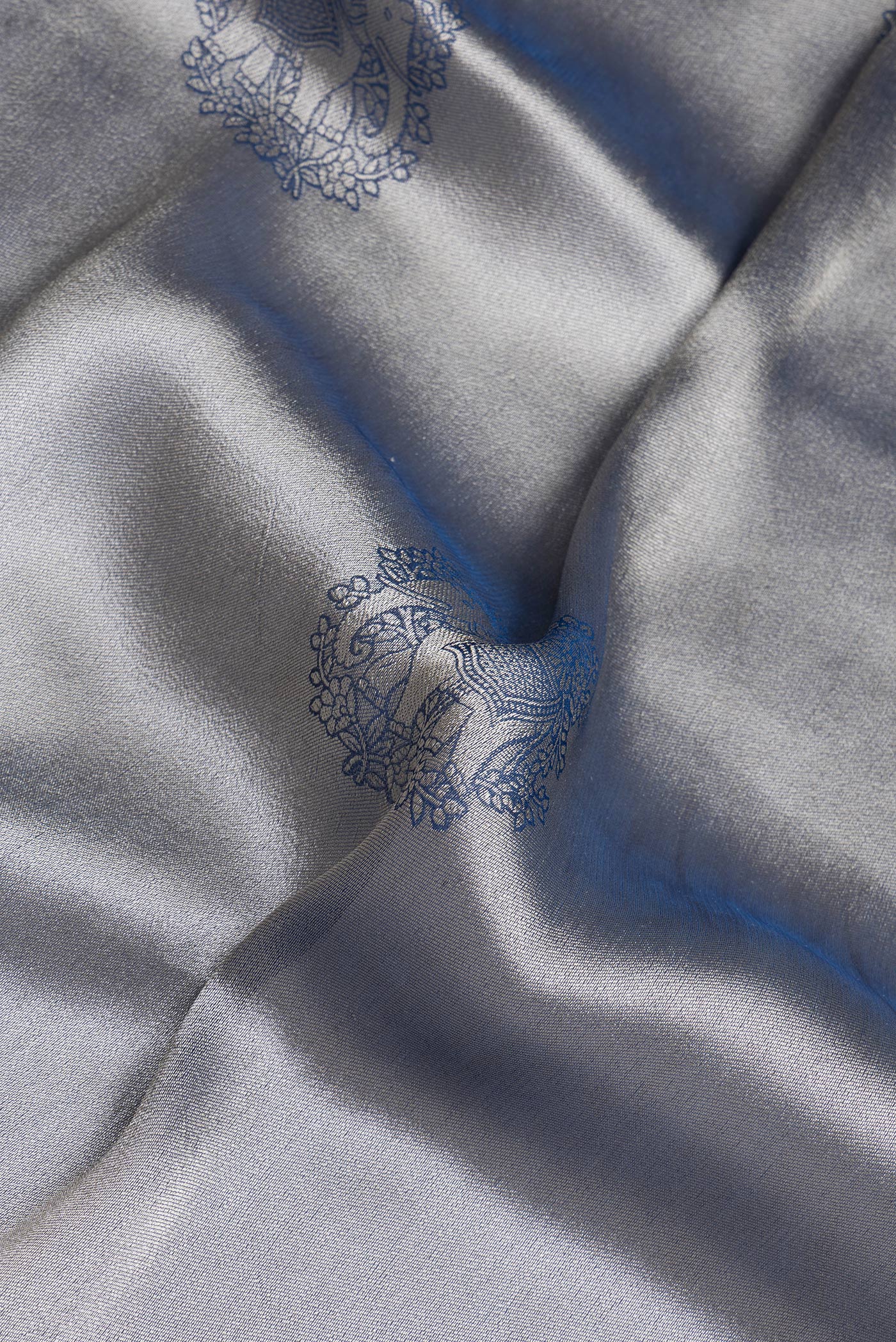 Close up of Blue Grey Dual Tone Blended Banarasi Silk Saree with Zari Brocade on the body and Fancy Border.  displaying folds