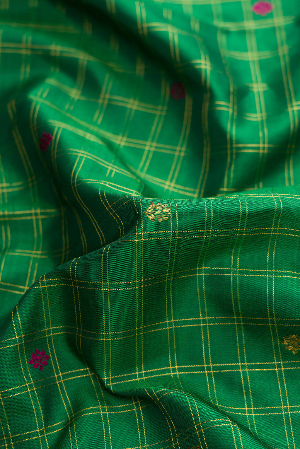Close up of Pure Silk Pure Zari Green Dual Tone Kanjivaram Saree with Checked design on the body and Zari And Thread Border.  displaying folds