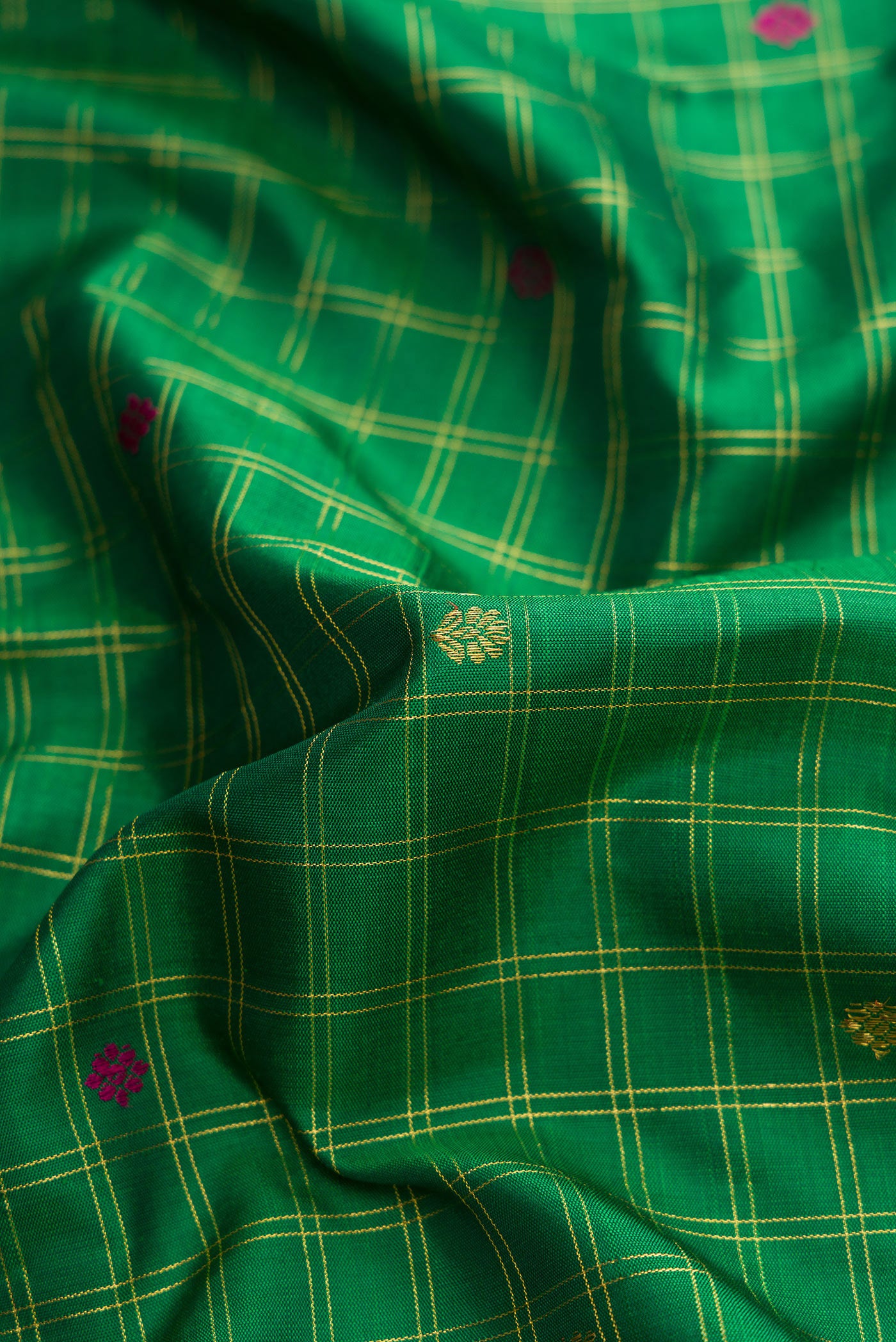 Close up of Pure Silk Pure Zari Green Dual Tone Kanjivaram Saree with Checked design on the body and Zari And Thread Border.  displaying folds