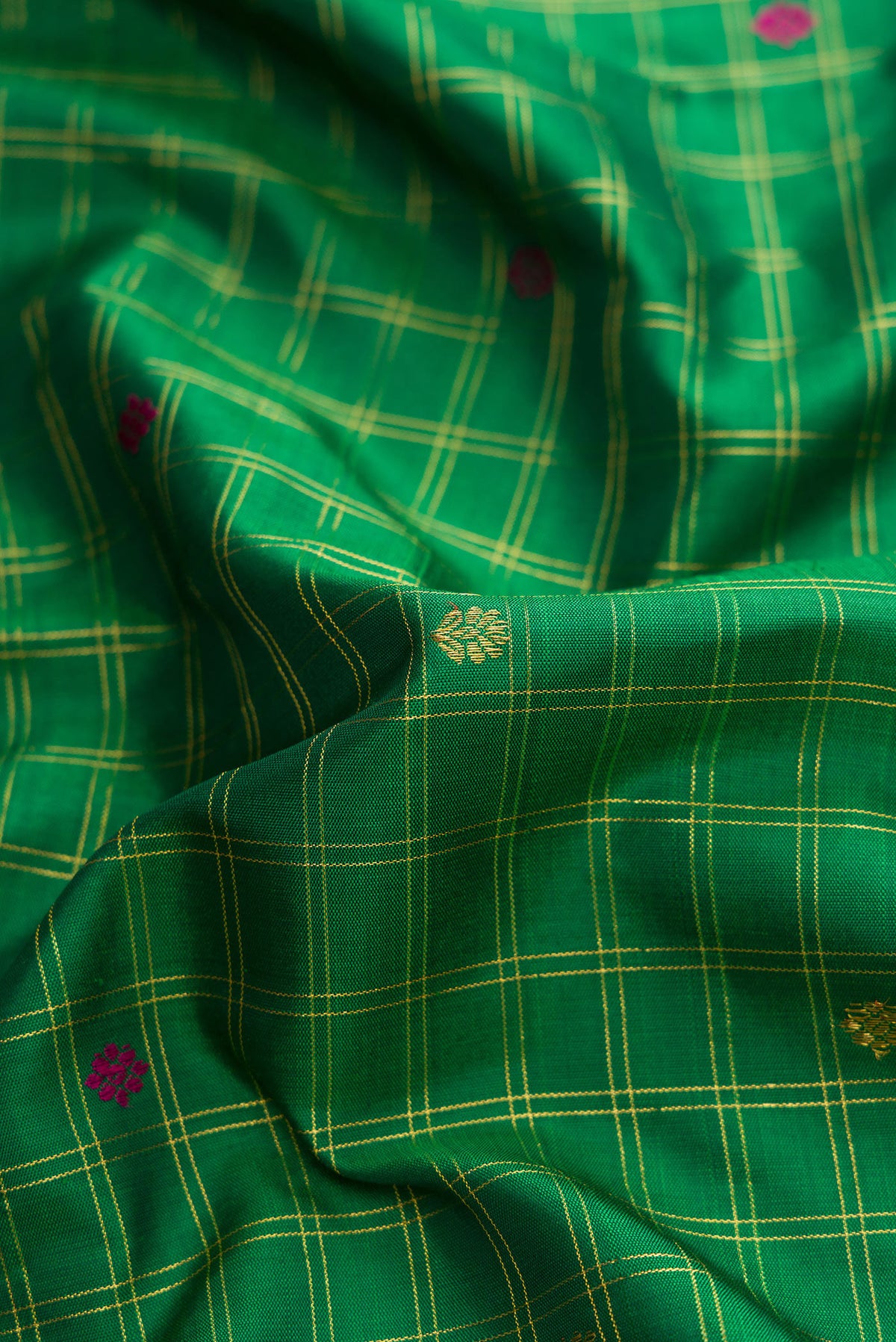 Close up of Pure Silk Pure Zari Green Dual Tone Kanjivaram Saree with Checked design on the body and Zari And Thread Border.  displaying folds