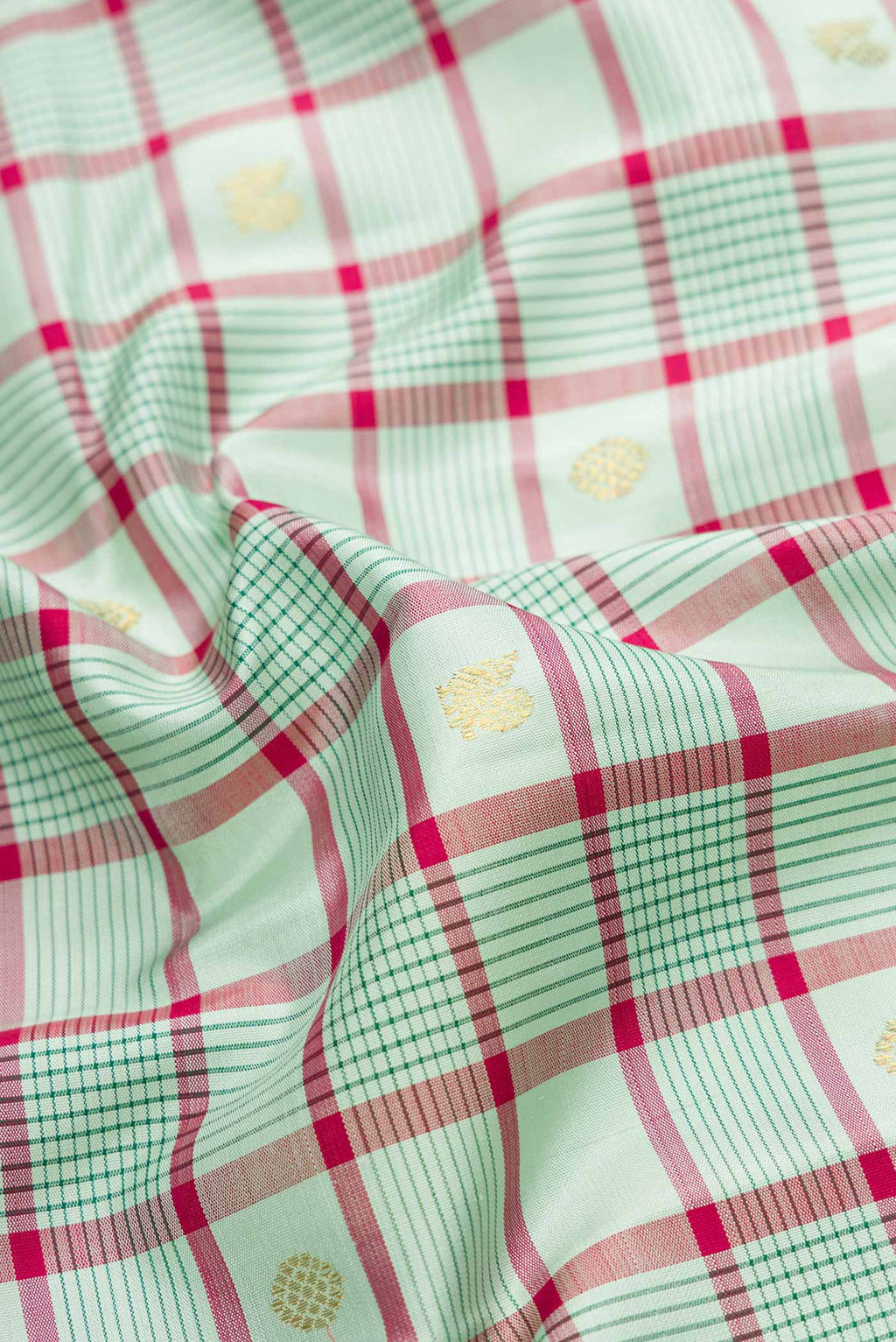 Close up of Pure Silk Pure Zari Light Green Dual Tone Kanjivaram Saree with Checked design on the body and Zari Border.  displaying folds