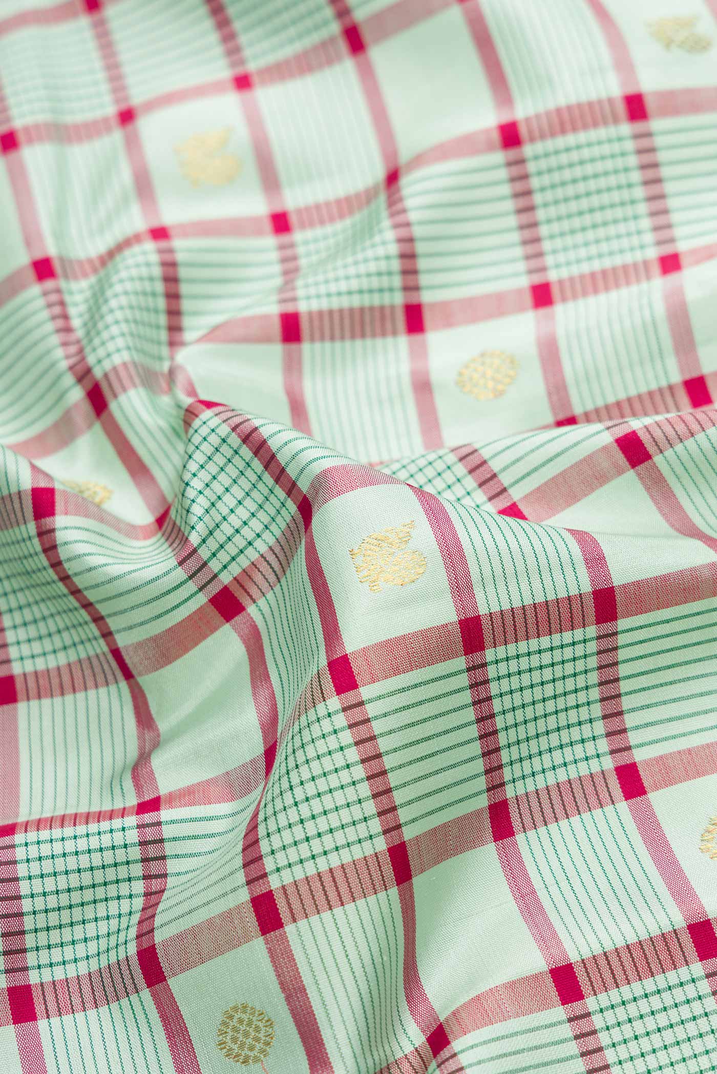 Close up of Pure Silk Pure Zari Light Green Dual Tone Kanjivaram Saree with Checked design on the body and Zari Border.  displaying folds