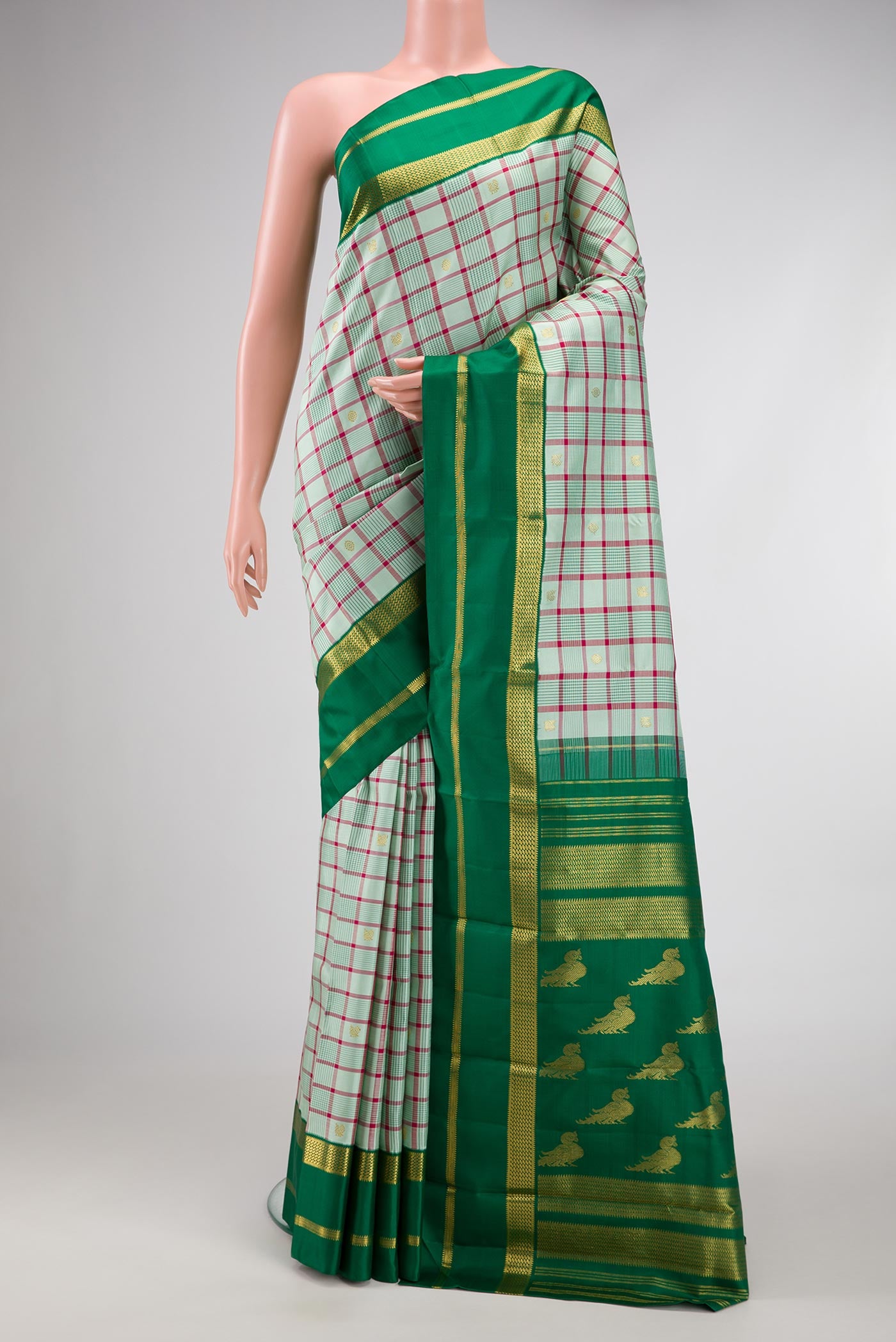 Pure Silk Pure Zari Light Green Dual Tone Kanjivaram Saree with Checked design on the body and Zari Border.  displayed on a mannequin