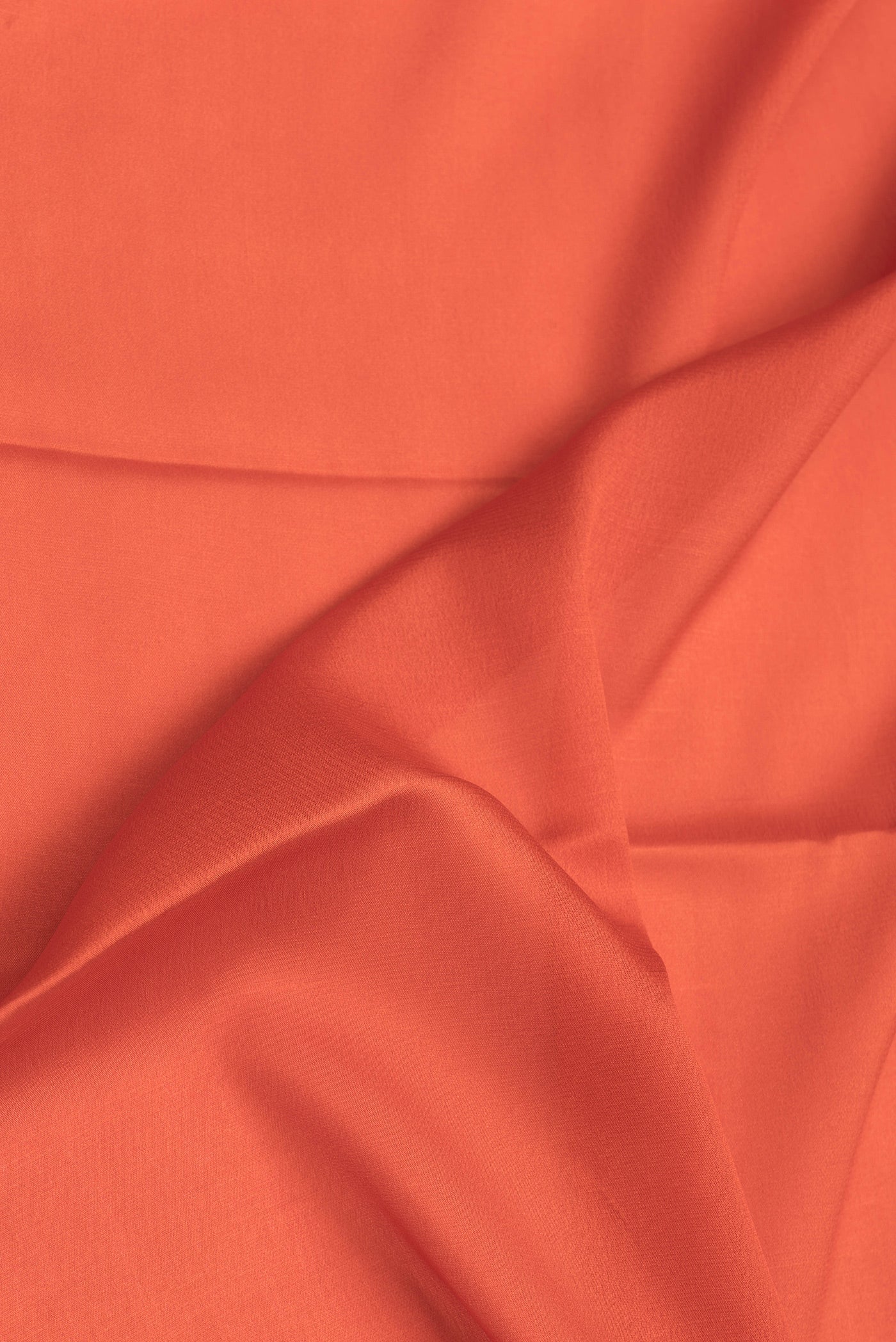 Close up of Orange Mysore Crepe Saree with Plain Body and Zari Border.  displaying folds