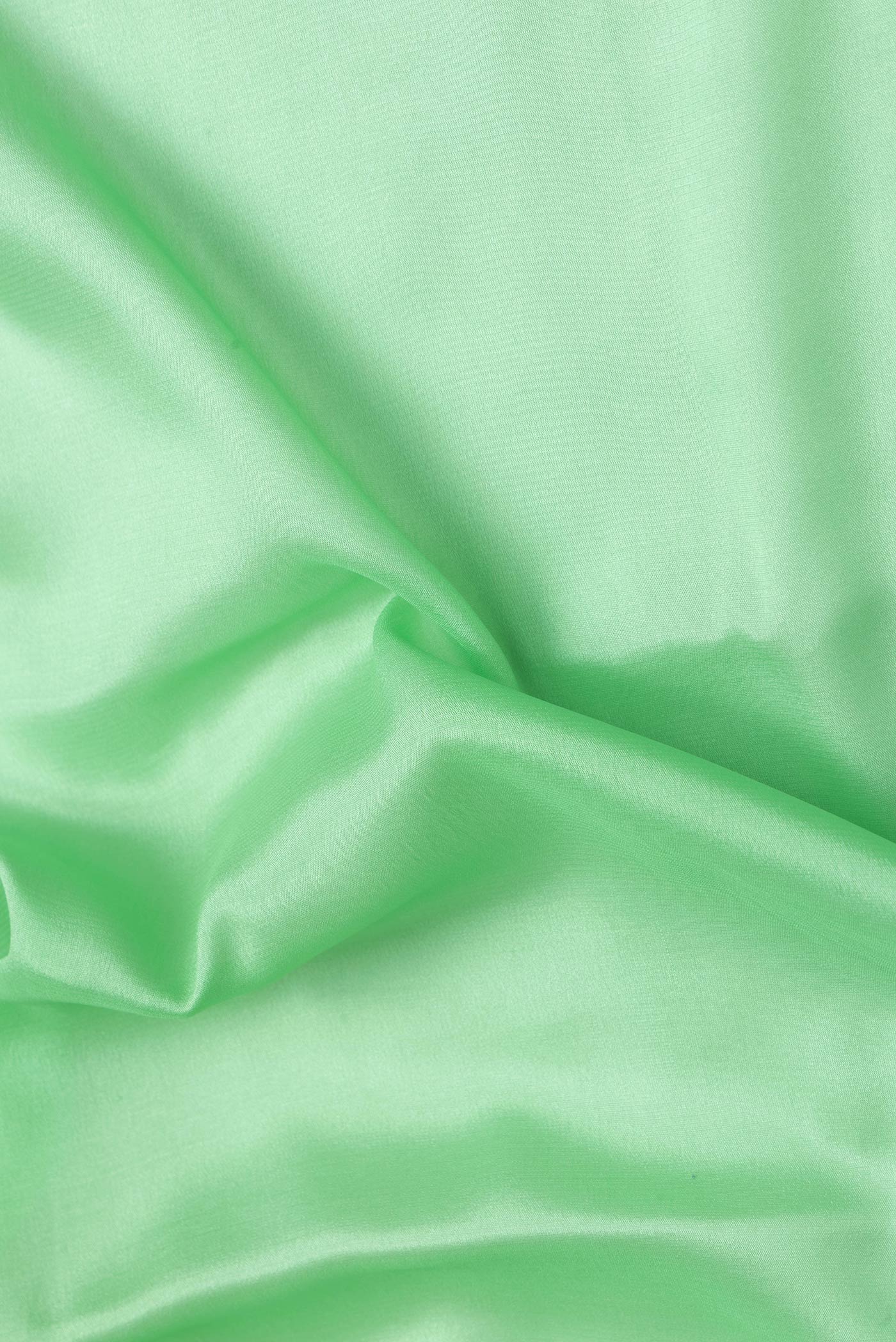 Close up of Pista Green Dual Tone Mysore Silk Saree with Plain Body and Zari Border.  displaying folds