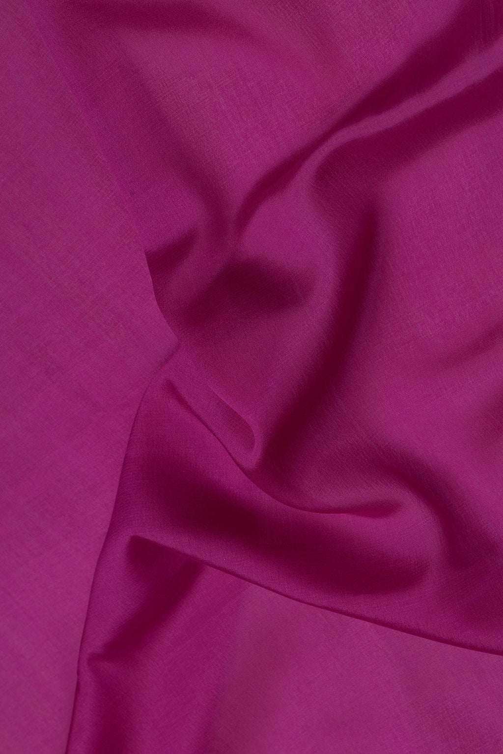 Close up of Magenta Mysore Crepe Saree with Plain Body and Zari Border.  displaying folds