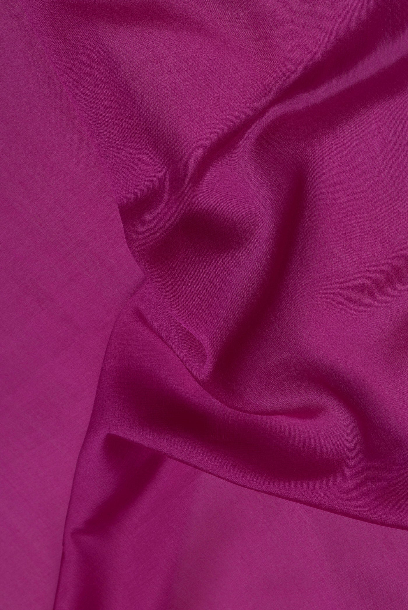 Close up of Magenta Mysore Crepe Saree with Plain Body and Zari Border.  displaying folds
