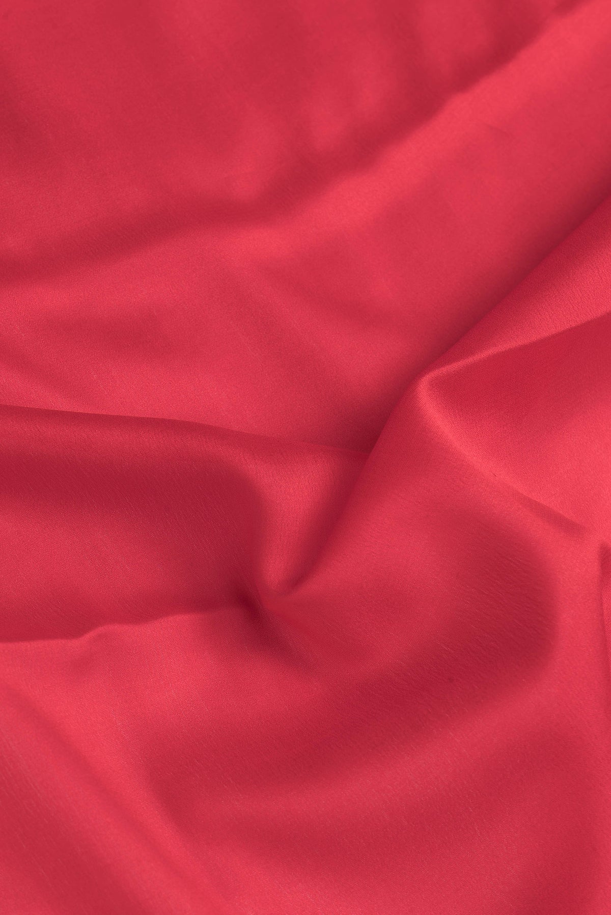 Close up of Red Dual Tone Mysore Crepe Saree with Plain Body and Zari Border.  displaying folds