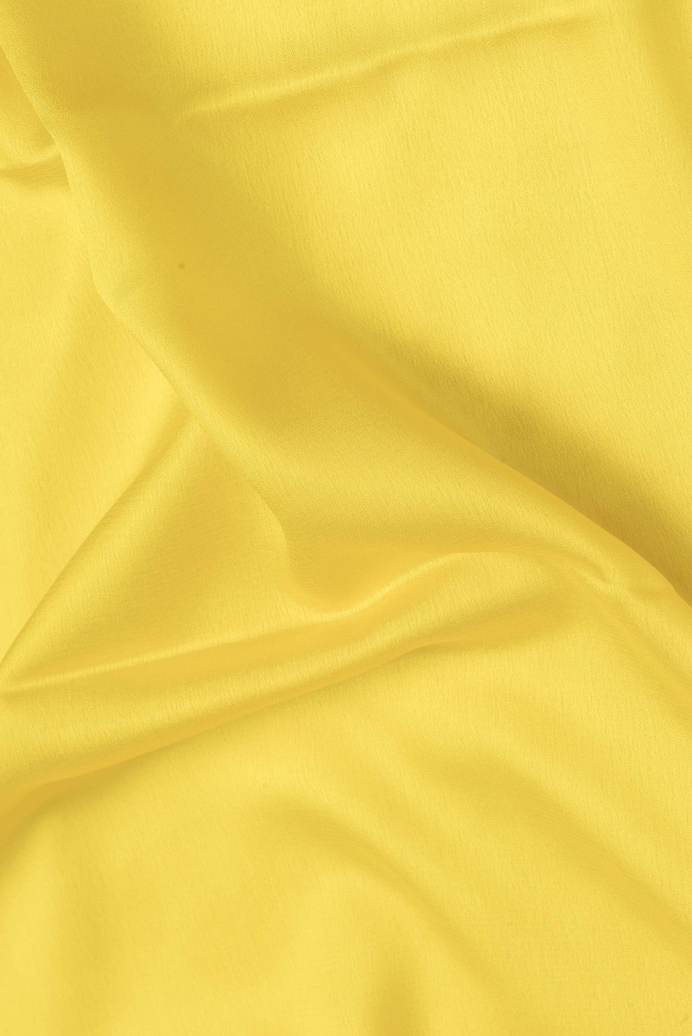 Close up of Yellow Dual Tone Mysore Crepe Saree with Plain Body and Zari Border.  displaying folds