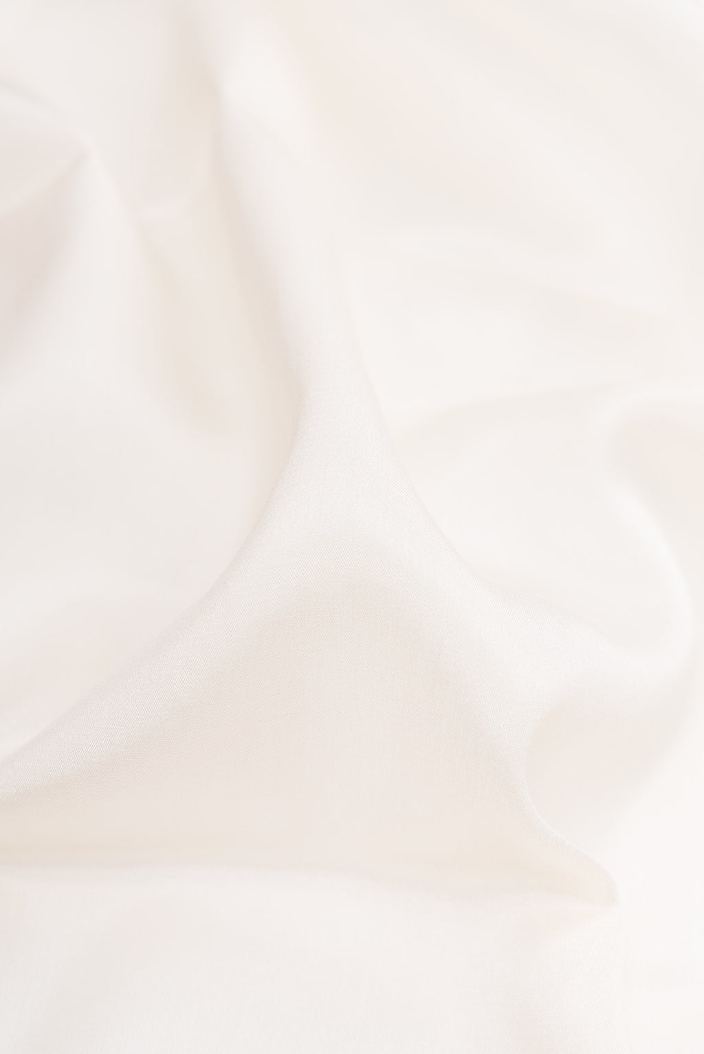Close up of Off White Dual Tone Mysore Silk Saree with Plain Body and Zari Border.  displaying folds