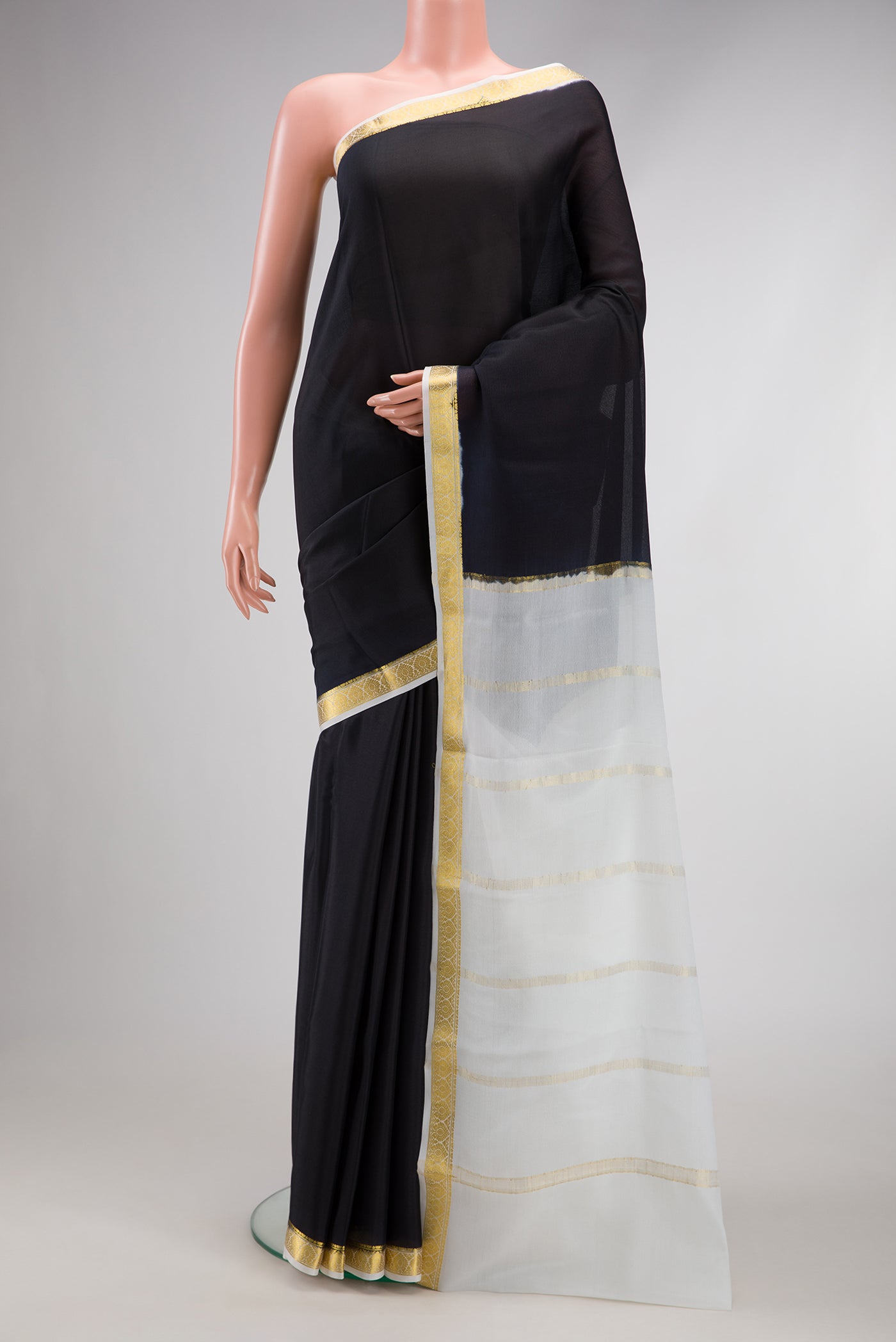 Black Mysore Crepe Saree with Plain Body and Zari Border.  displayed on a mannequin