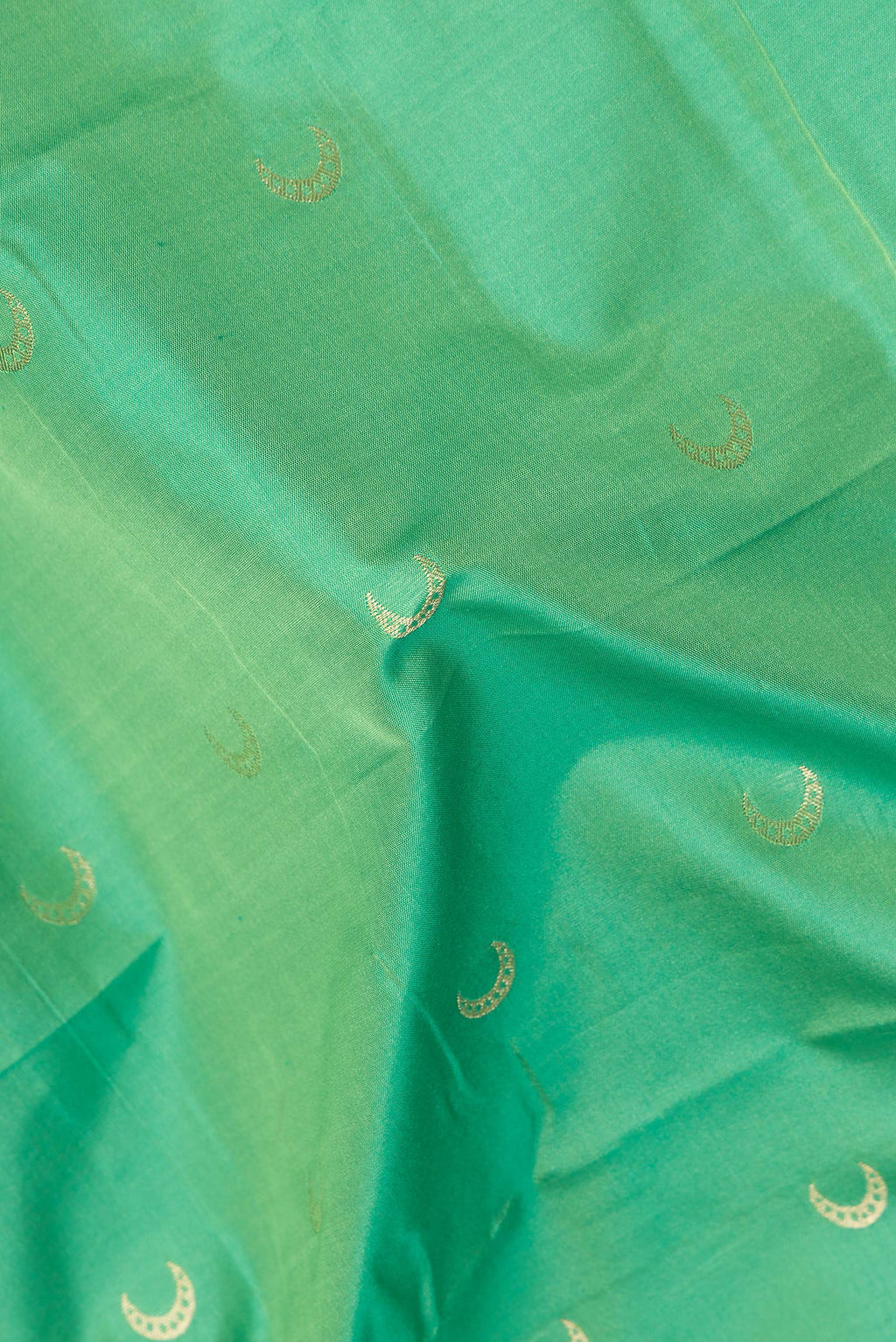 Close up of Green Blended Paithani Silk Saree with Zari Butta on the body and Zari Border.  displaying folds