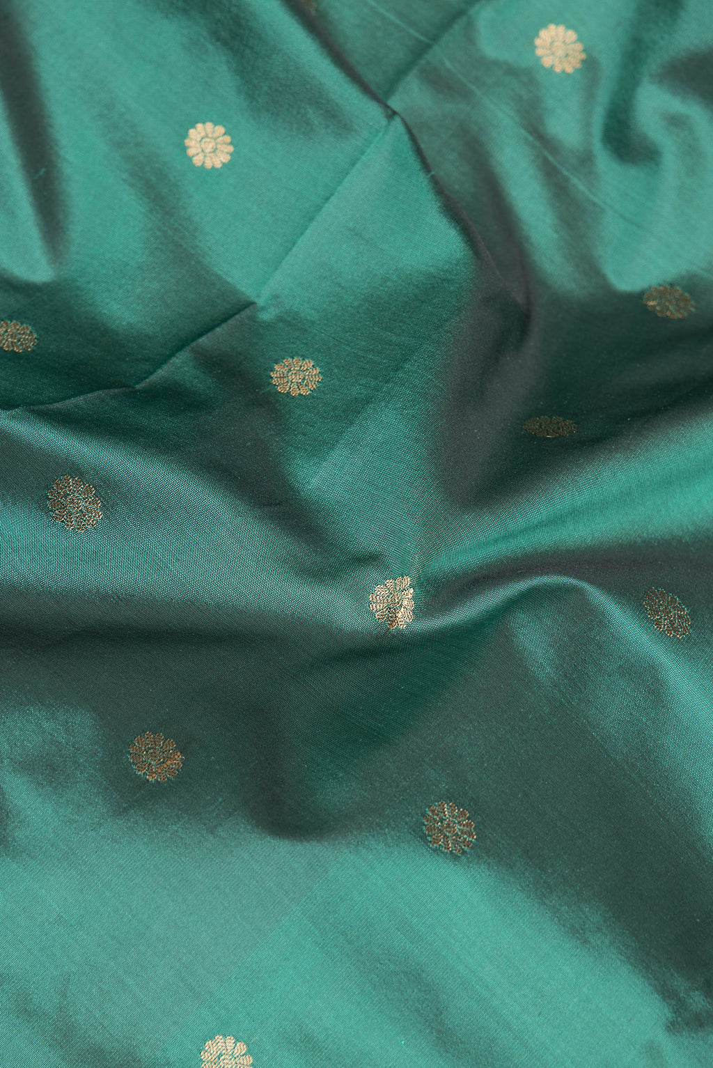 Close up of Green Blended Paithani Silk Saree with Zari Butta on the body and Zari Border.  displaying folds