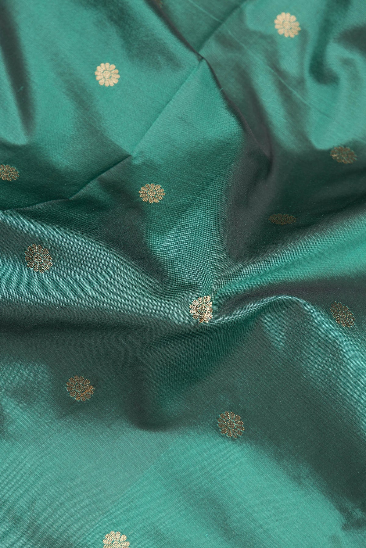 Close up of Green Blended Paithani Silk Saree with Zari Butta on the body and Zari Border.  displaying folds
