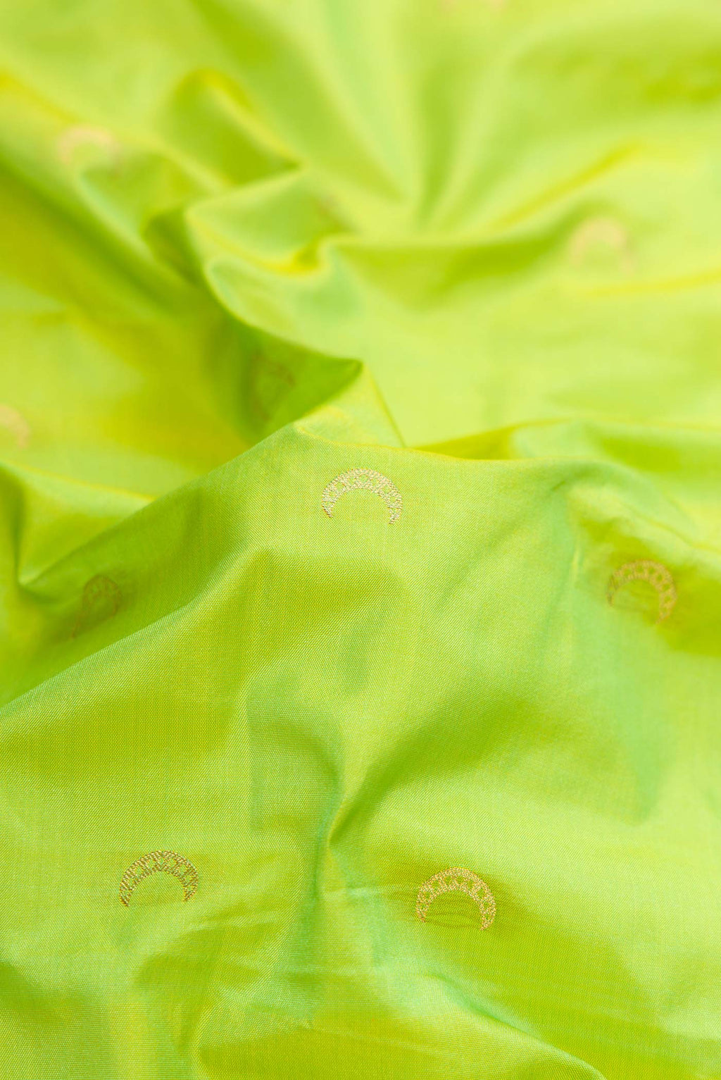 Close up of Parrot Green Dual Tone Paithani Silk Saree with Zari Butta on the body and Zari Border.  displaying folds