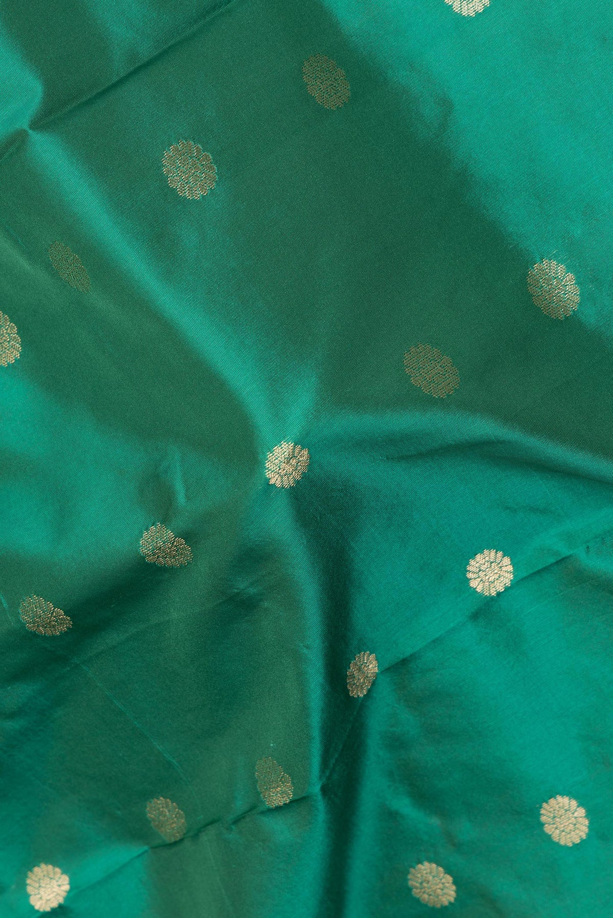 Close up of Green Blended Paithani Silk Saree with Zari Butta on the body and Zari Border.  displaying folds