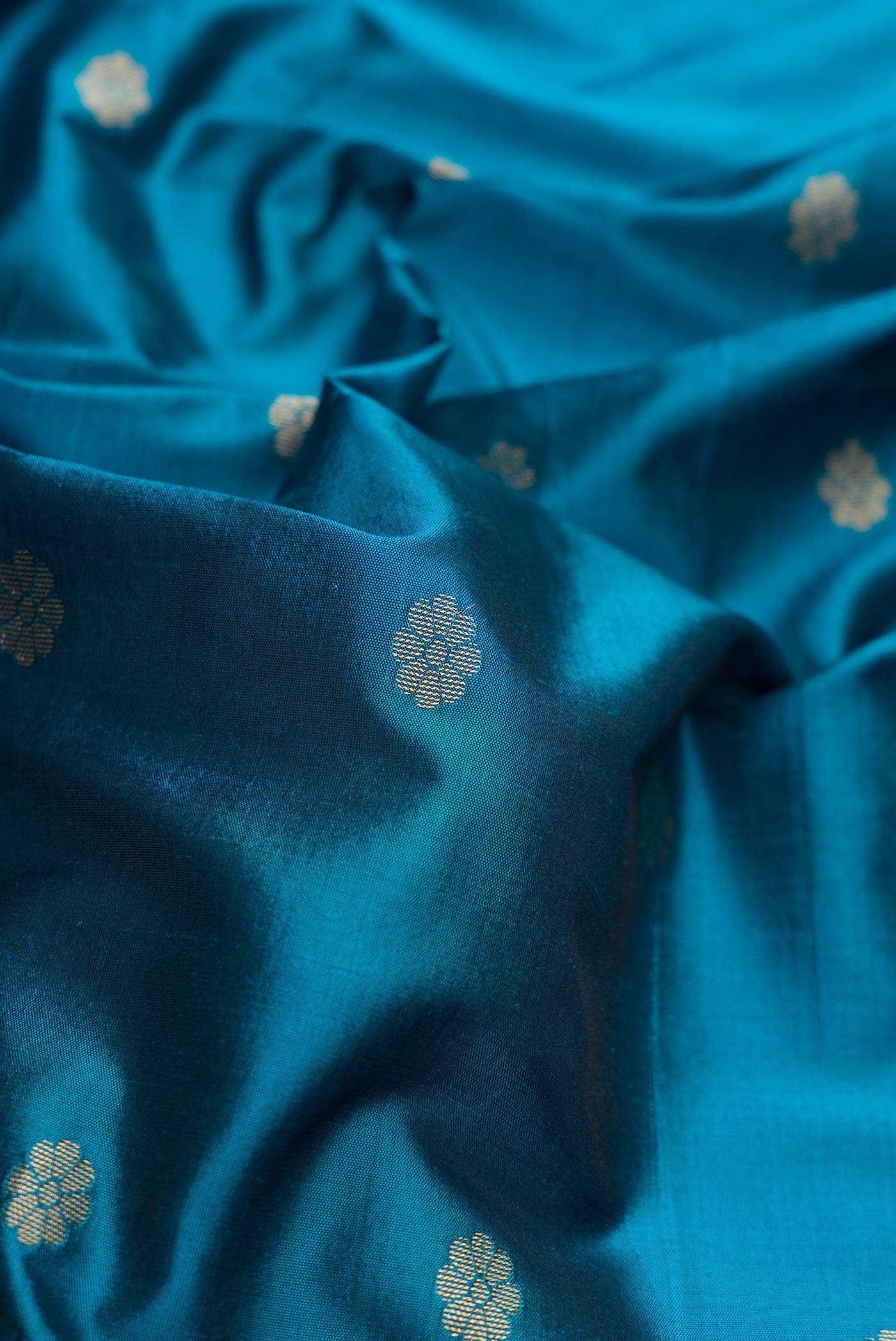 Close up of Blue Blended Bangalore Silk Saree with Zari Butta on the body and Zari Border displaying folds