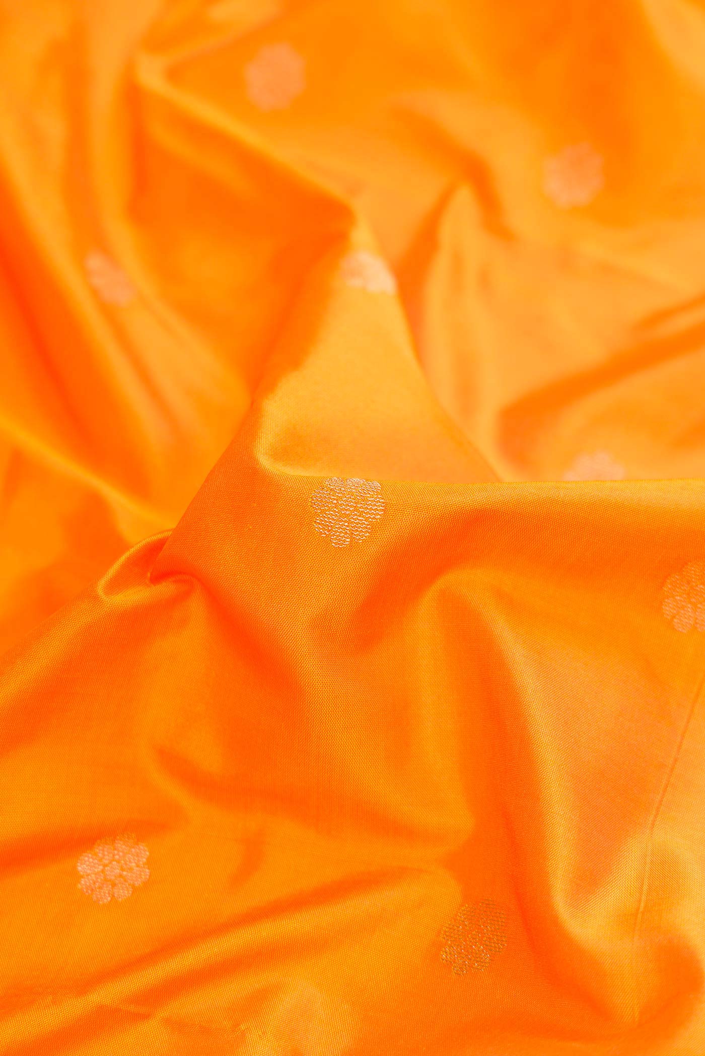 Close up of Yellow Blended Bangalore Silk Saree with Zari Butta on the body and Zari Border displaying folds
