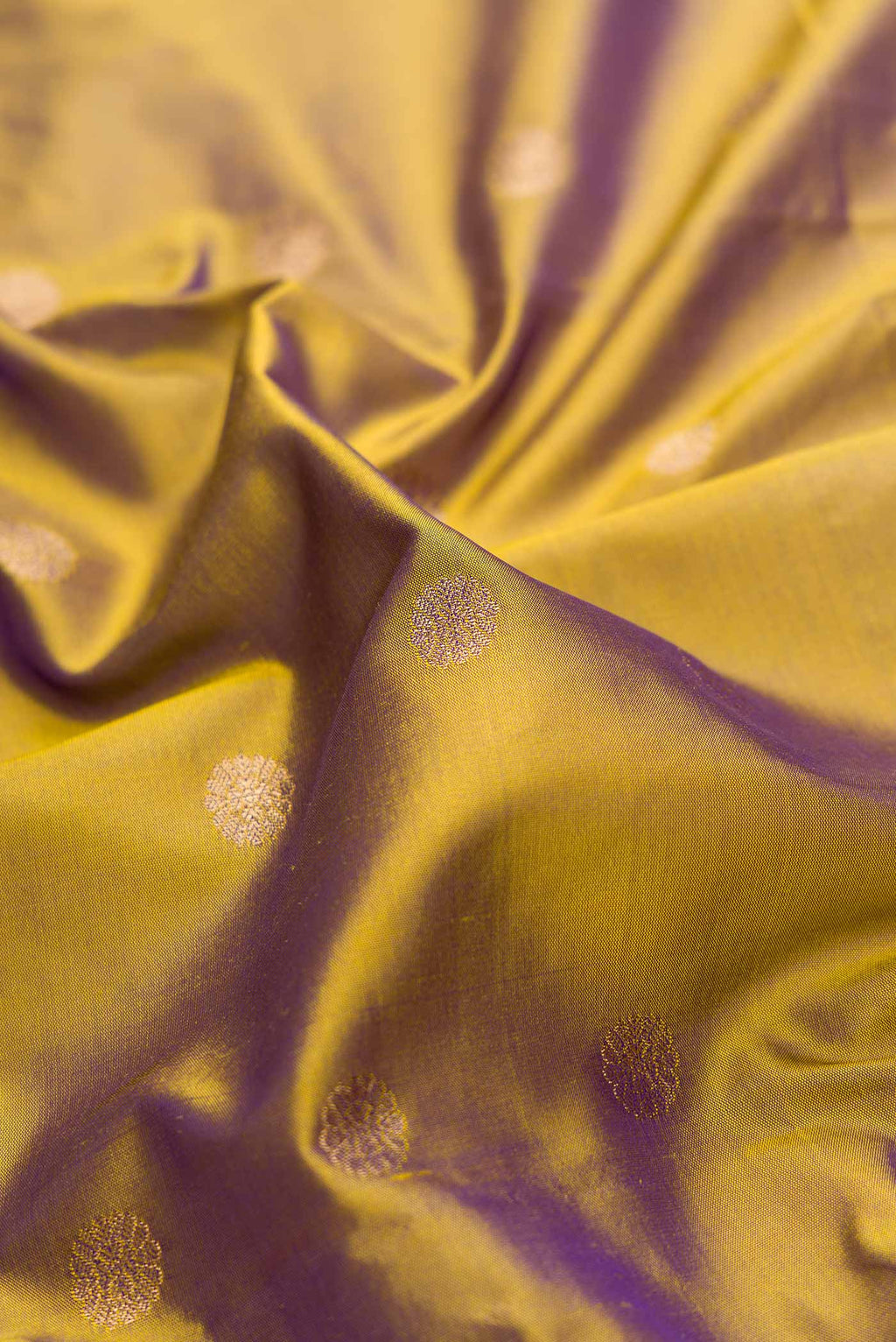 Close up of Green with Purple Color Blended Bangalore Silk Saree with Zari Butta on the body and Zari Border displaying folds