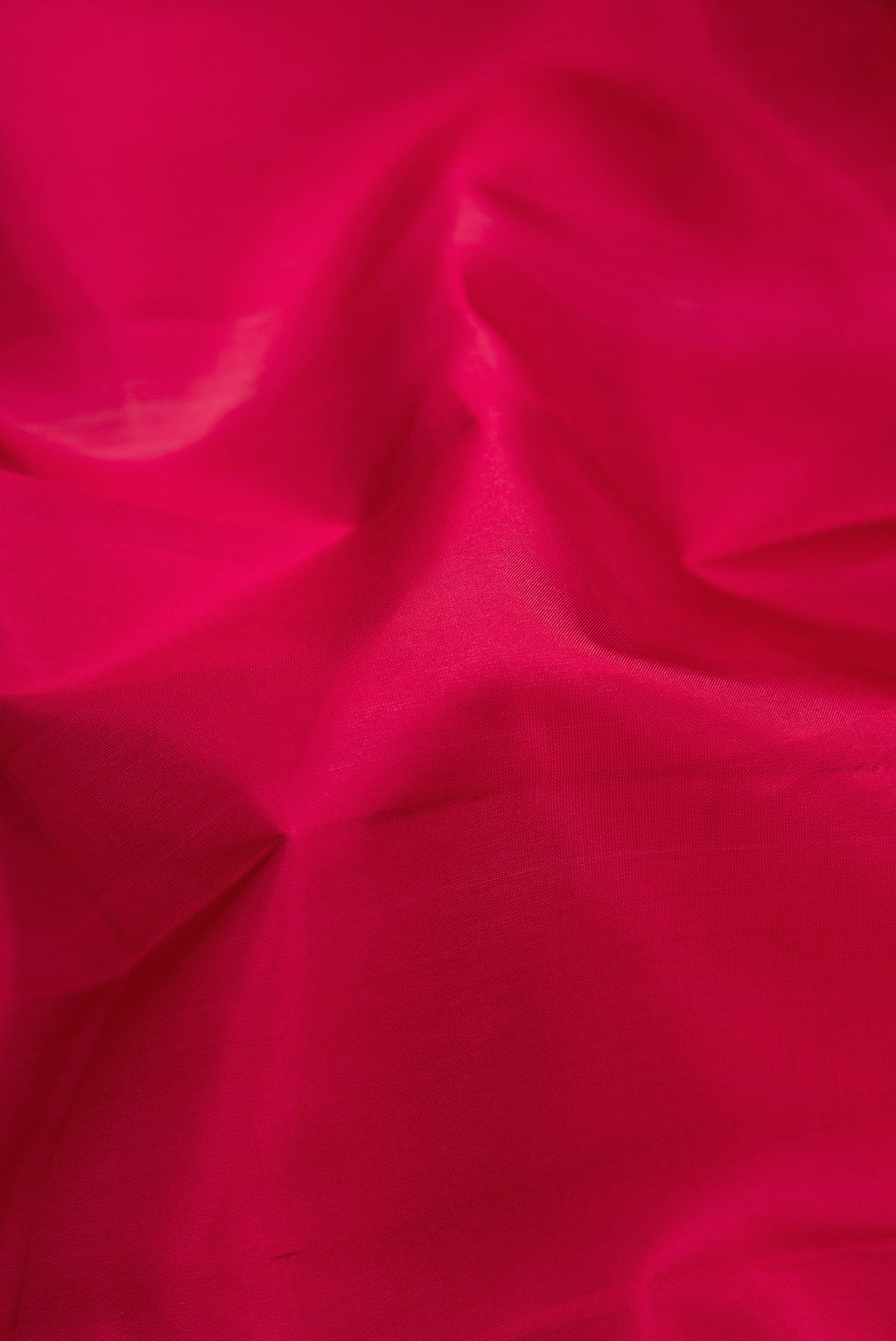Close up of Maroon Kanjivaram Silk Saree with Plain Body and Thread Border.  displaying folds