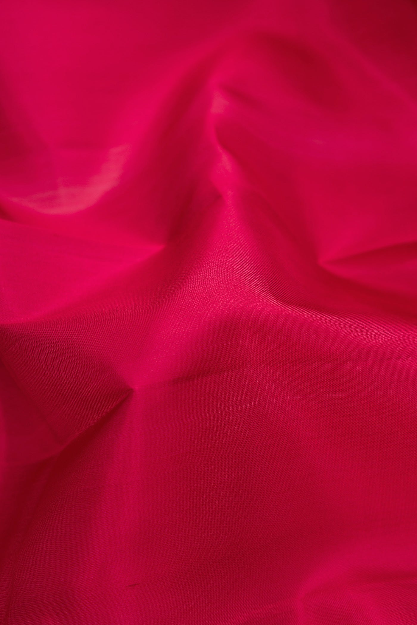 Close up of Maroon Kanjivaram Silk Saree with Plain Body and Thread Border.  displaying folds