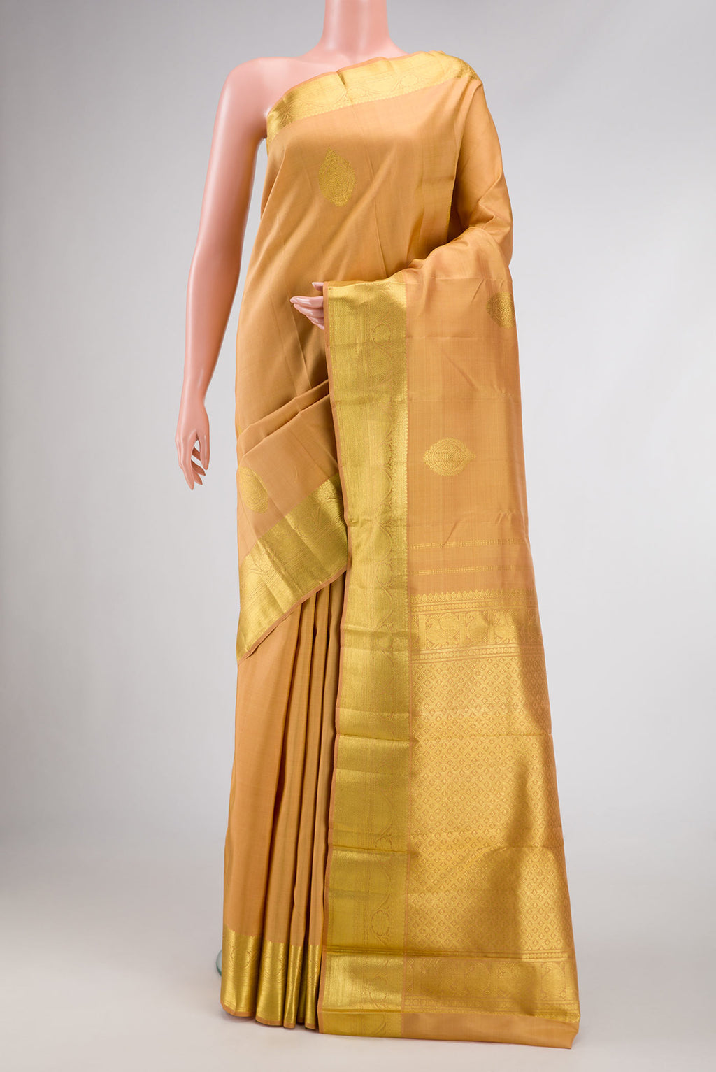 Sandal Dual Tone Kanjivaram Silk Saree with Zari Butta on the body and Zari Border.  displayed on a mannequin
