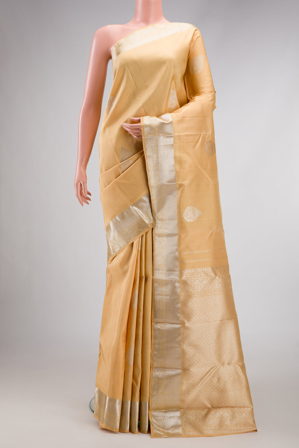 Sandal Dual Tone Kanjivaram Silk Saree with Zari Butta on the body and Zari Border.  displayed on a mannequin