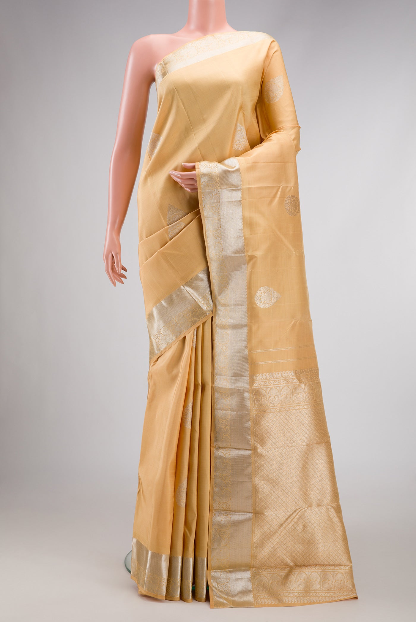 Sandal Dual Tone Kanjivaram Silk Saree with Zari Butta on the body and Zari Border.  displayed on a mannequin