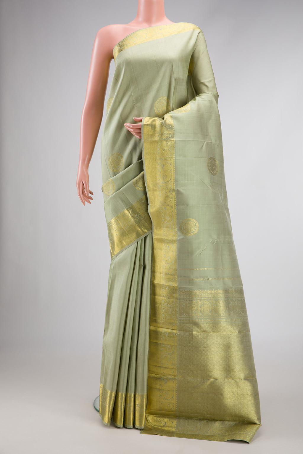 Pista Green Dual Tone Kanjivaram Silk Saree with Zari Butta on the body and Zari Border.  displayed on a mannequin