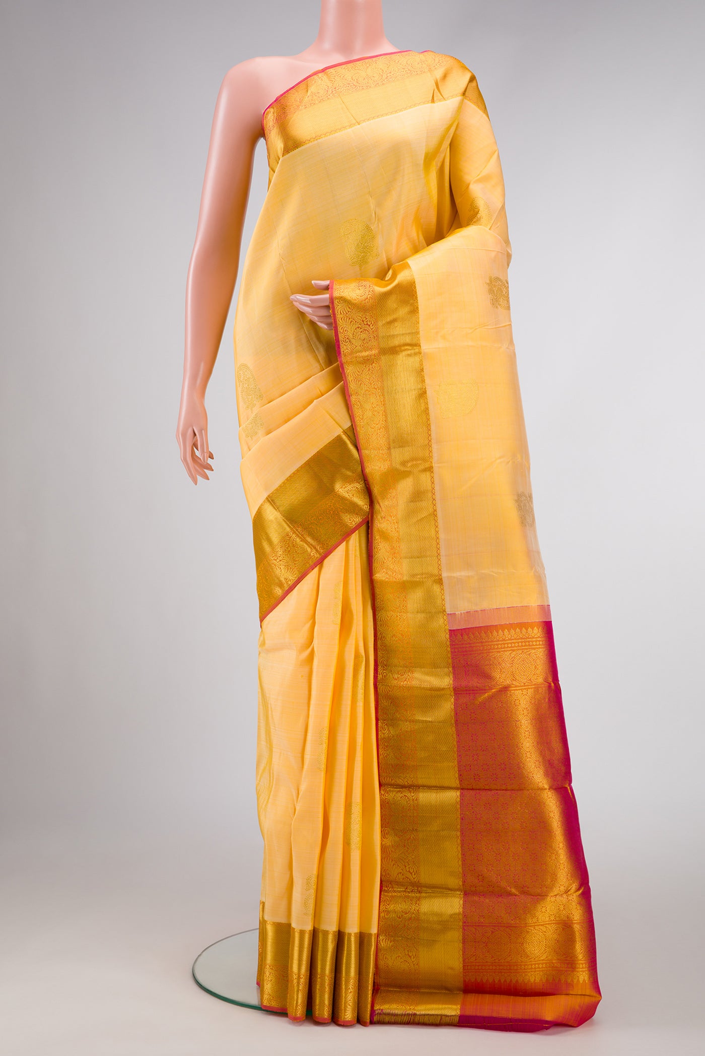 Sandal Dual Tone Kanjivaram Silk Saree with Zari Butta on the body and Zari Border.  displayed on a mannequin