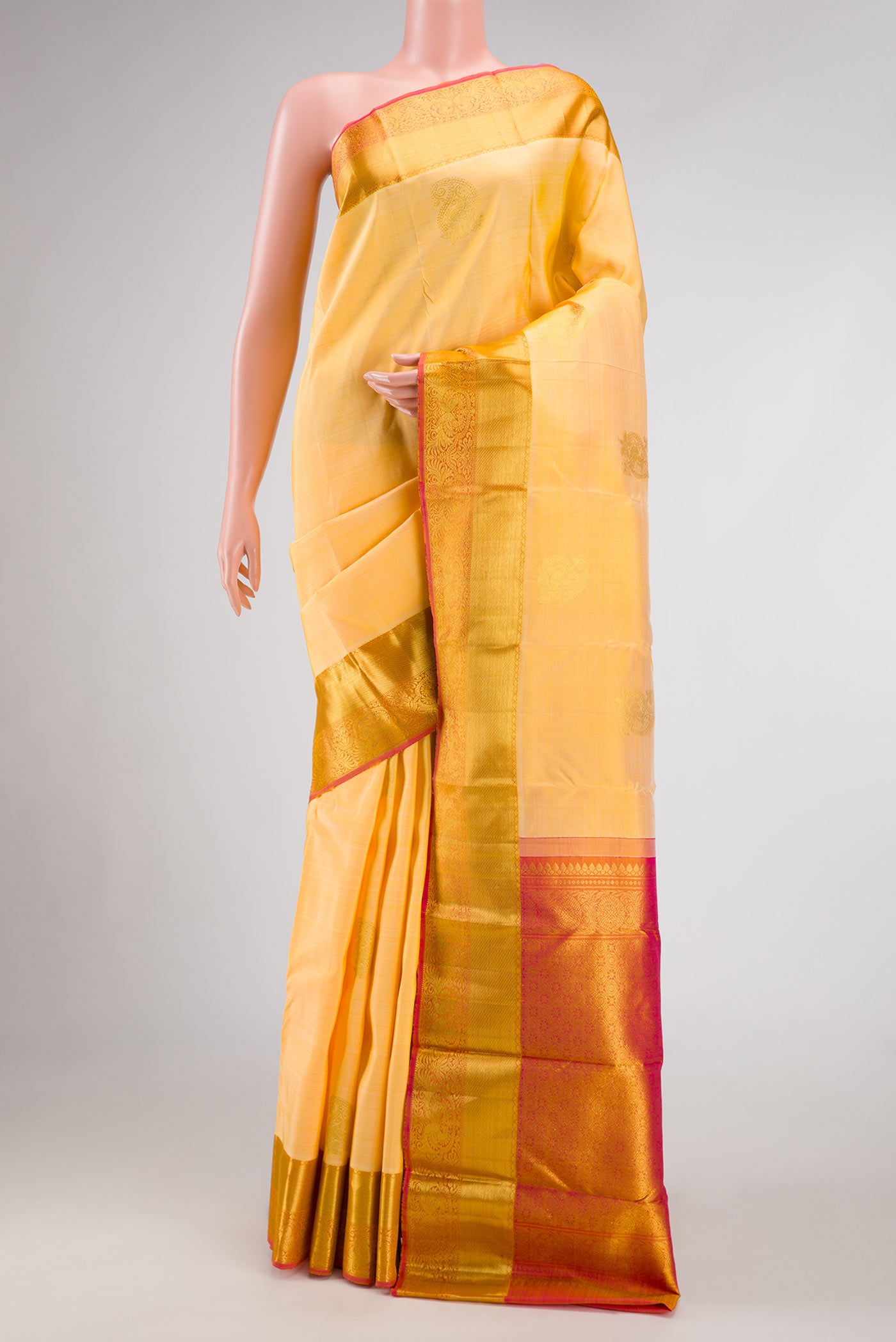 Sandal Dual Tone Kanjivaram Silk Saree with Zari Butta on the body and Zari Border.  displayed on a mannequin
