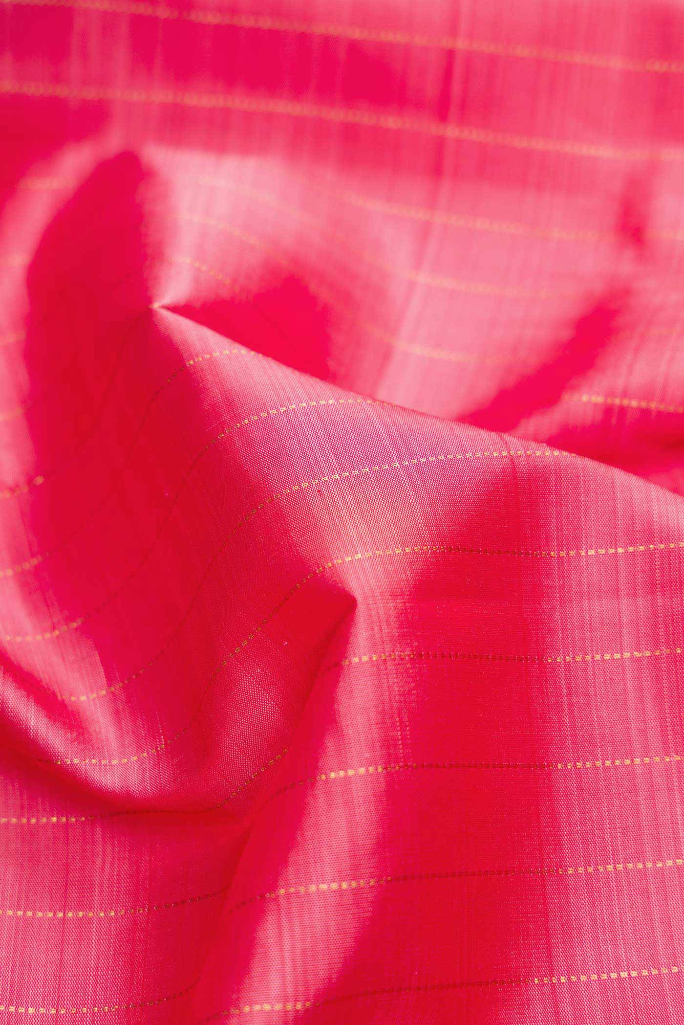 Close up of Pink Dual Tone Kanjivaram Silk Saree with Checked design on the body and Fancy Border.  displaying folds
