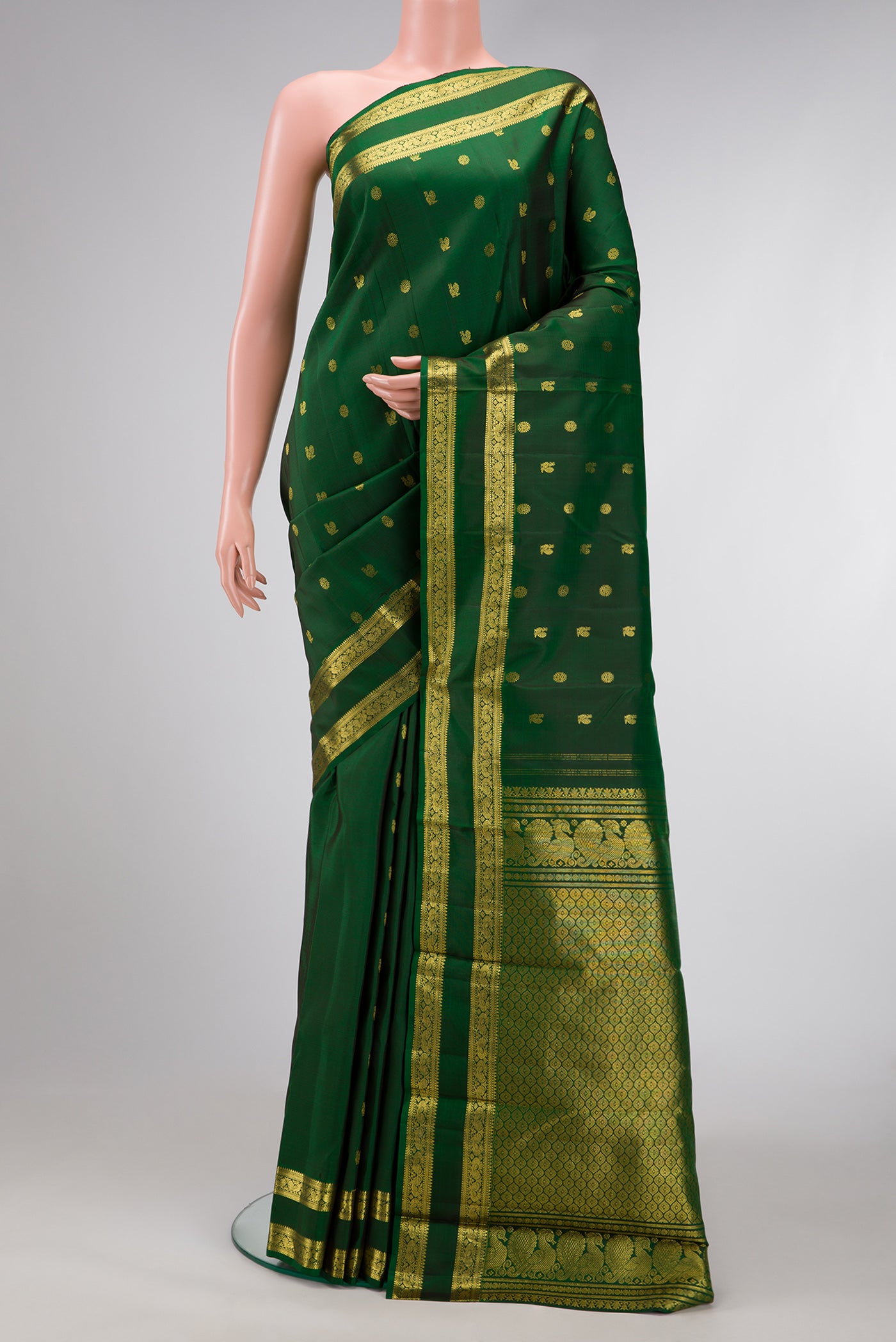 Green Dual Tone Kanjivaram Silk Saree with Zari Butta on the body and Zari Border.  displayed on a mannequin