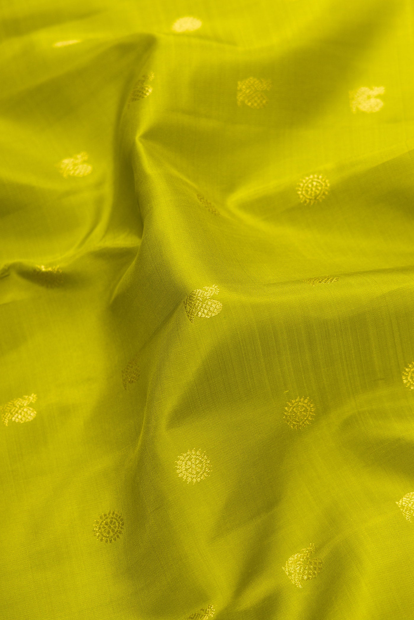 Close up of Parrot Green Dual Tone Kanjivaram Silk Saree with Zari Butta on the body and Zari Border.  displaying folds