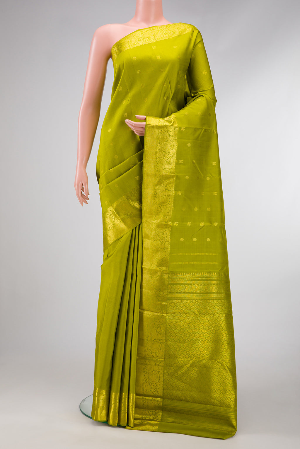 Parrot Green Dual Tone Kanjivaram Silk Saree with Zari Butta on the body and Zari Border.  displayed on a mannequin
