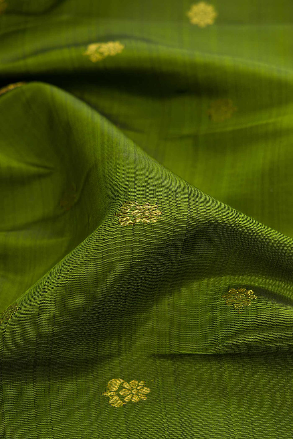 Close up of Mehandi Green Dual Tone Kanjivaram Silk Saree with Zari Butta on the body and Zari Border.  displaying folds