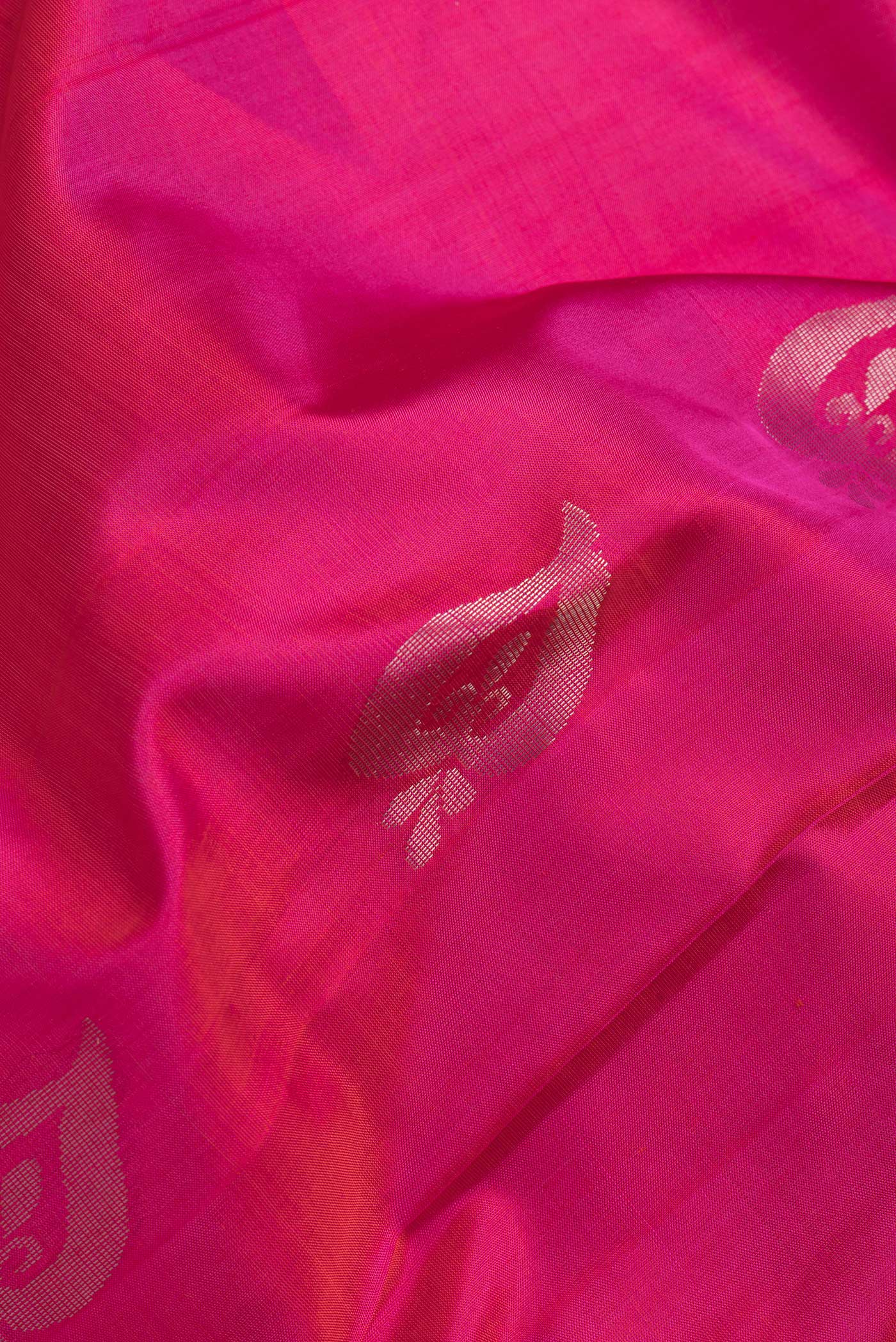Close up of Pink Dual Tone Uppada Silk Saree with Zari Butta on the body and Zari Border.  displaying folds