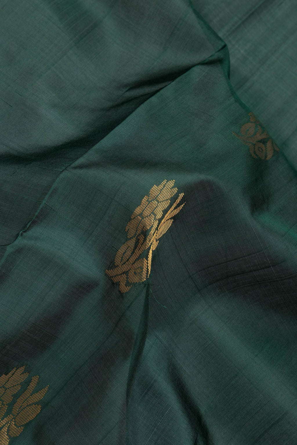 Close up of Bottle Green Dual Tone Uppada Silk Saree with Zari Butta on the body and Fancy Border.  displaying folds