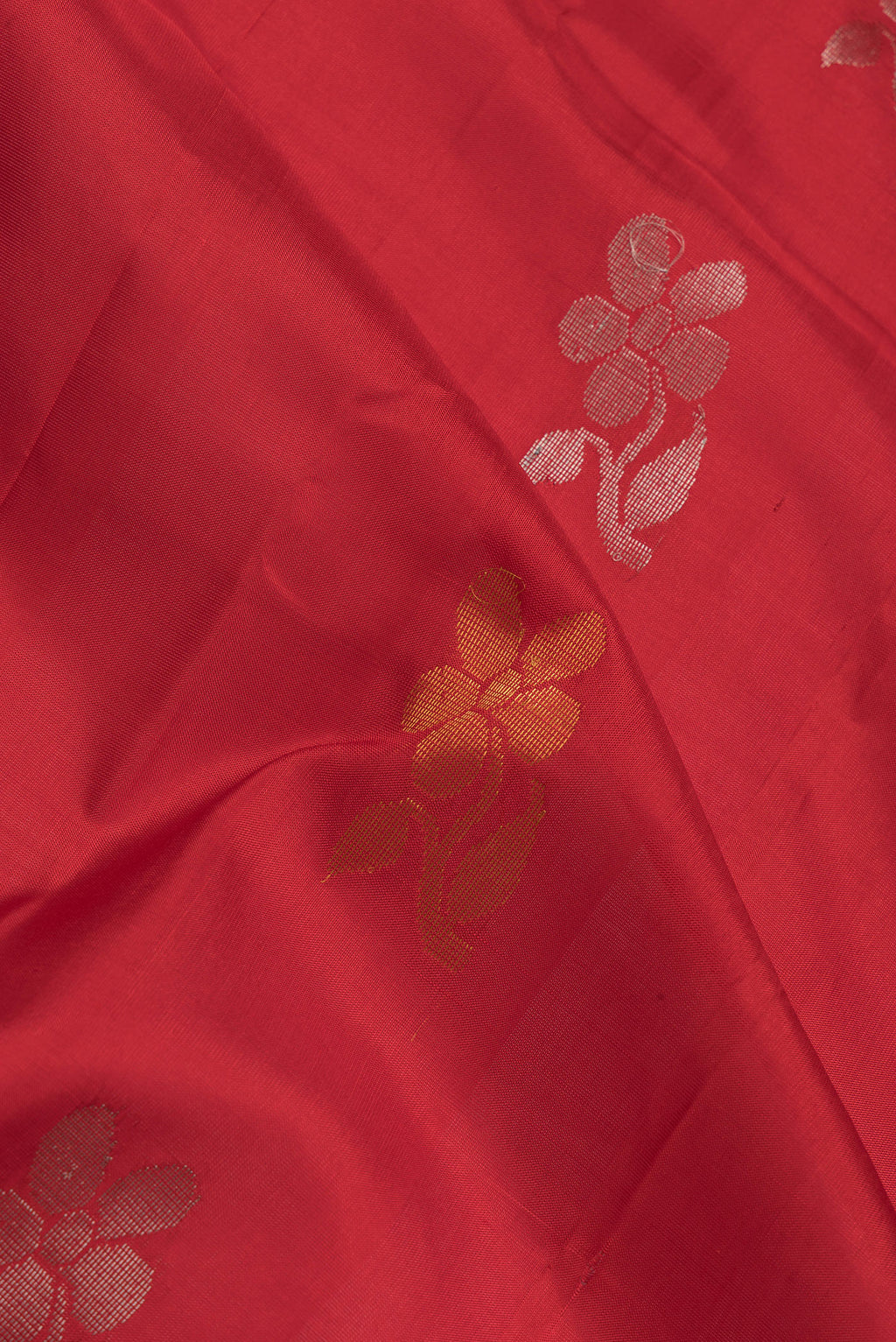 Close up of Red Dual Tone Uppada Silk Saree with Zari Butta on the body and Fancy Border.  displaying folds