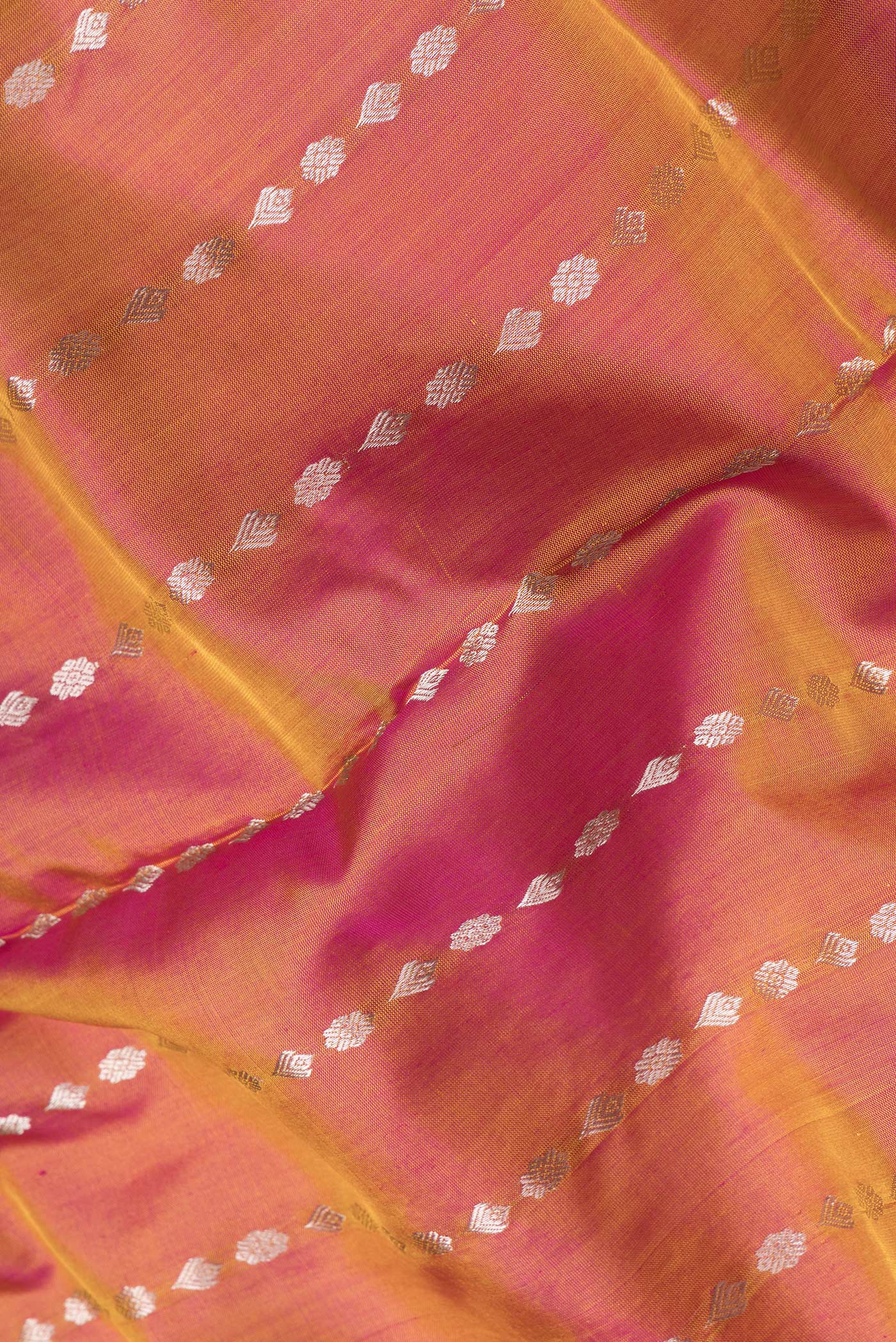 Close up of Mustard Dual Tone Uppada Silk Saree with Zari Butta on the body and Zari Border.  displaying folds