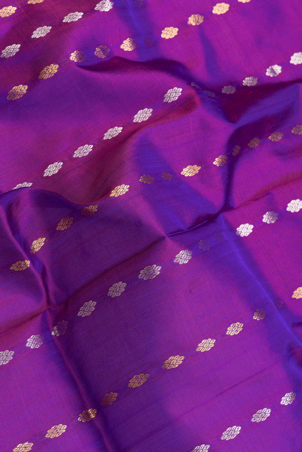 Close up of Peacock Blue Dual Tone Uppada Silk Saree with Zari Butta on the body and Zari Border.  displaying folds