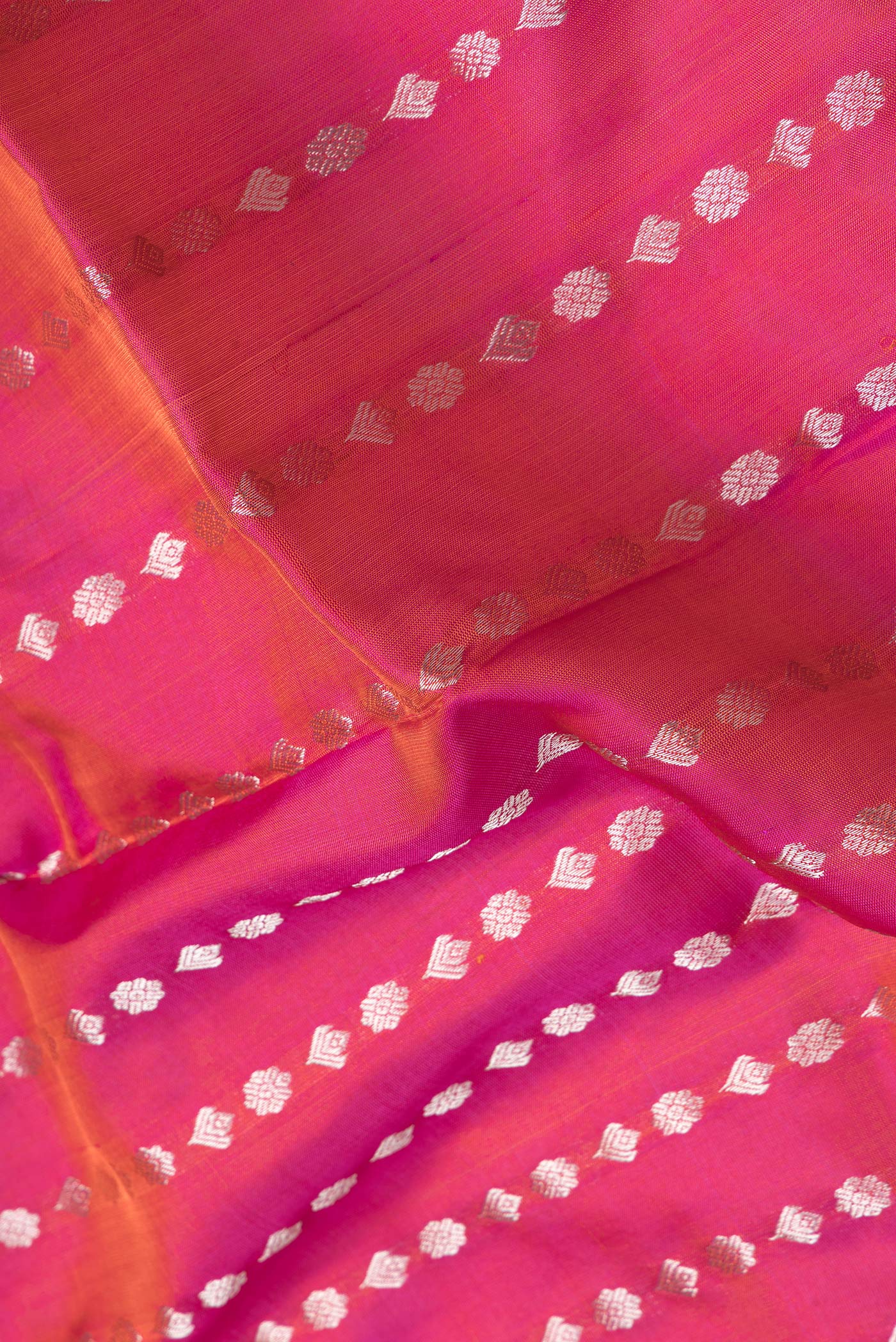 Close up of Pink Dual Tone Uppada Silk Saree with Zari Butta on the body and Zari Border.  displaying folds