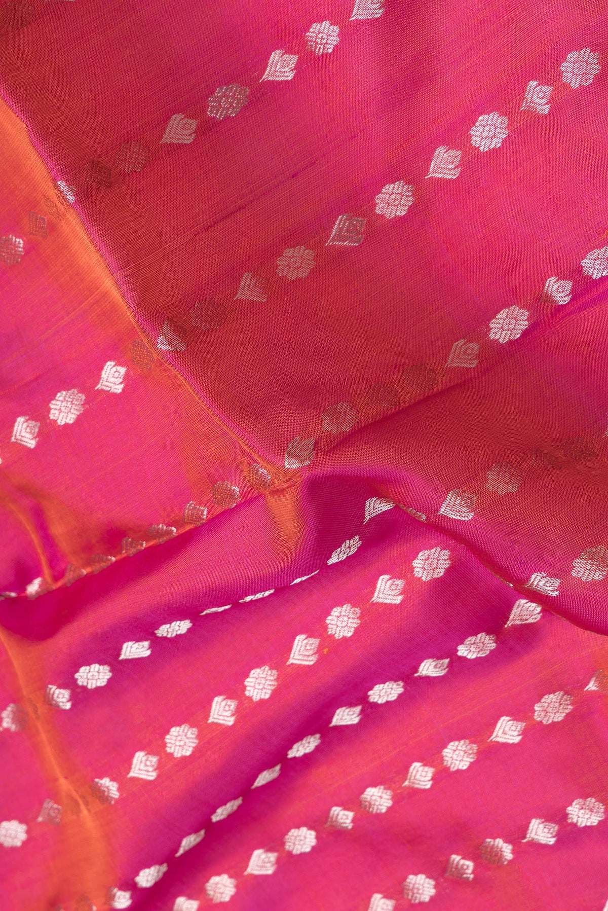 Close up of Pink Dual Tone Uppada Silk Saree with Zari Butta on the body and Zari Border.  displaying folds