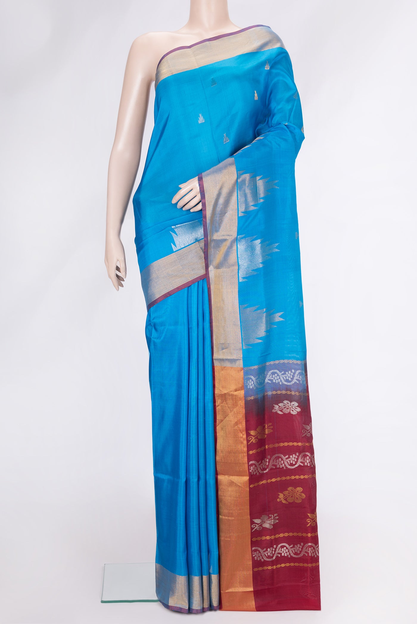 Sky Blue Dual Tone Uppada Silk Saree with Zari Butta on the body and Temple Border.  displayed on a mannequin