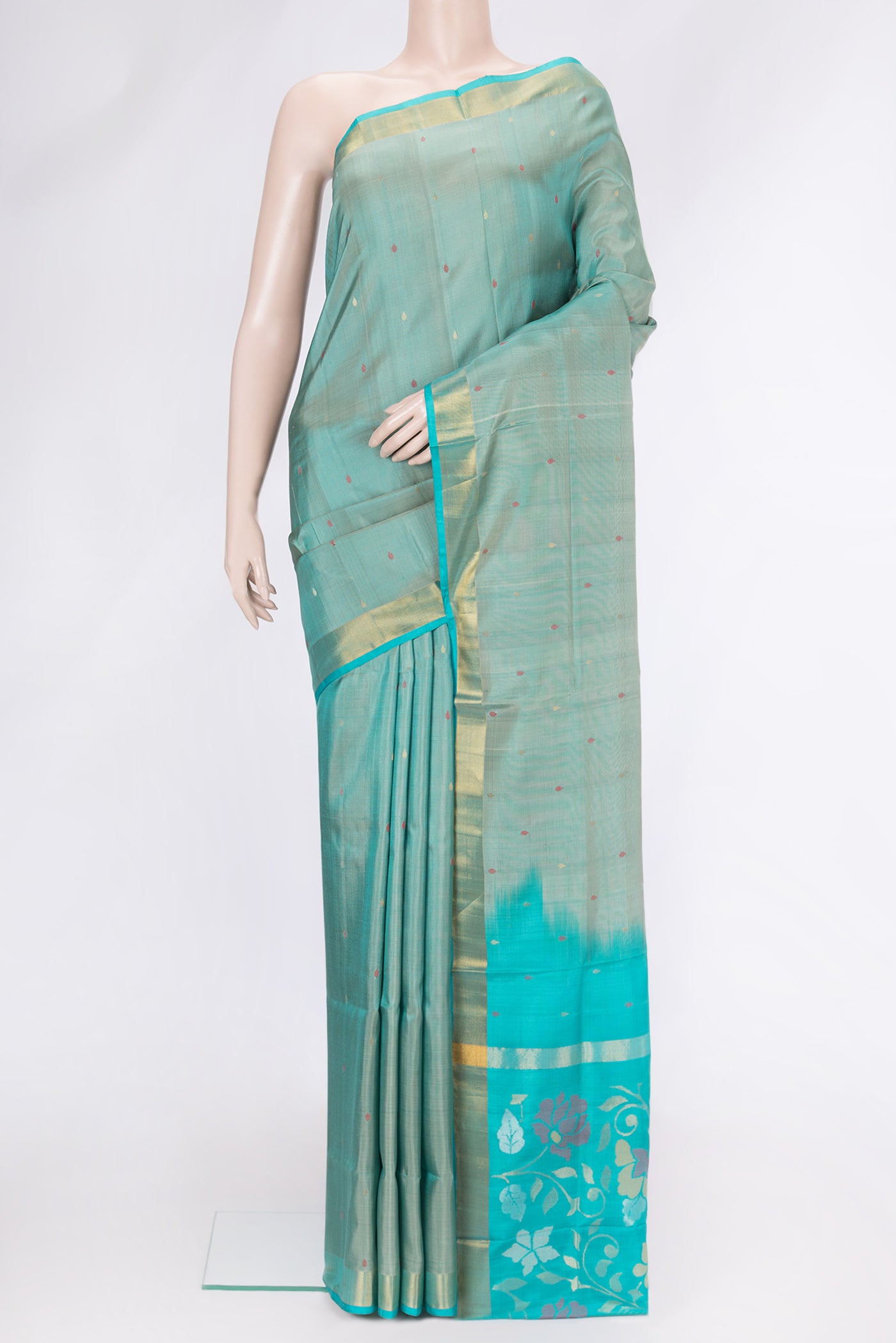 Sea Green Dual Tone Uppada Silk Saree with Zari And Thread Butta on the body and Zari Border.  displayed on a mannequin