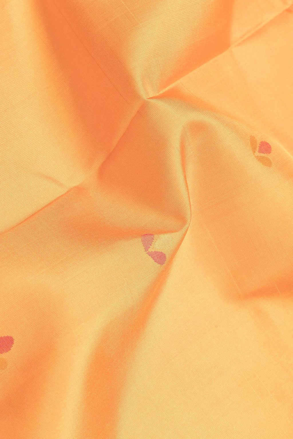 Close up of Orange Dual Tone Uppada Silk Saree with Zari And Thread Butta on the body and Zari Border.  displaying folds