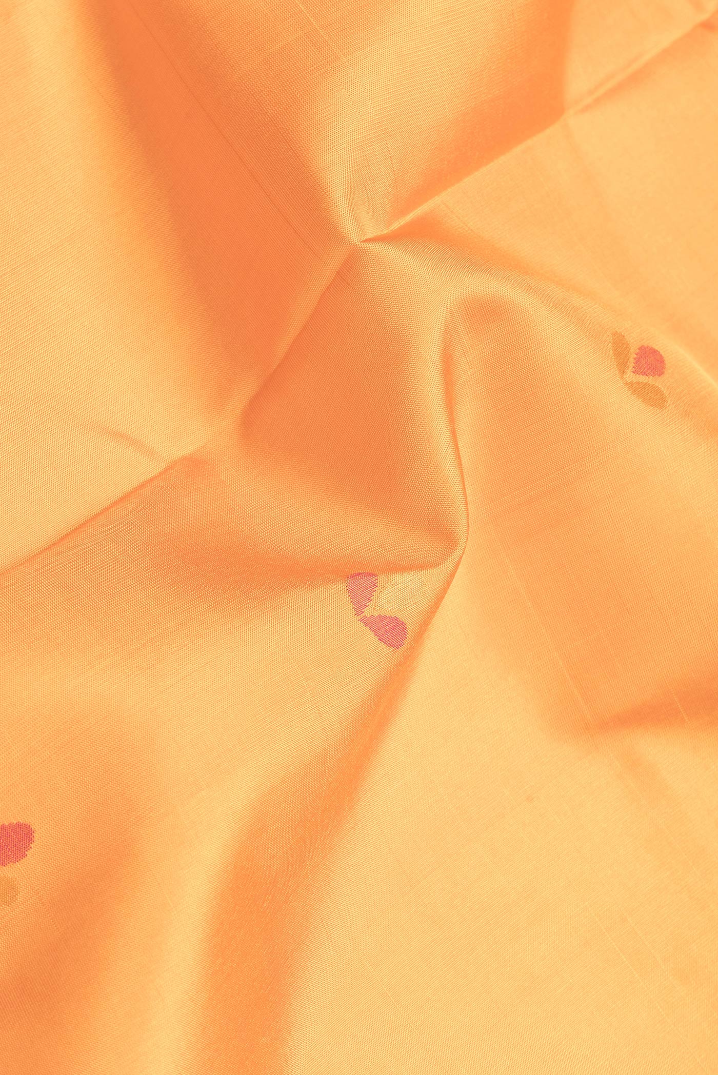 Close up of Orange Dual Tone Uppada Silk Saree with Zari And Thread Butta on the body and Zari Border.  displaying folds