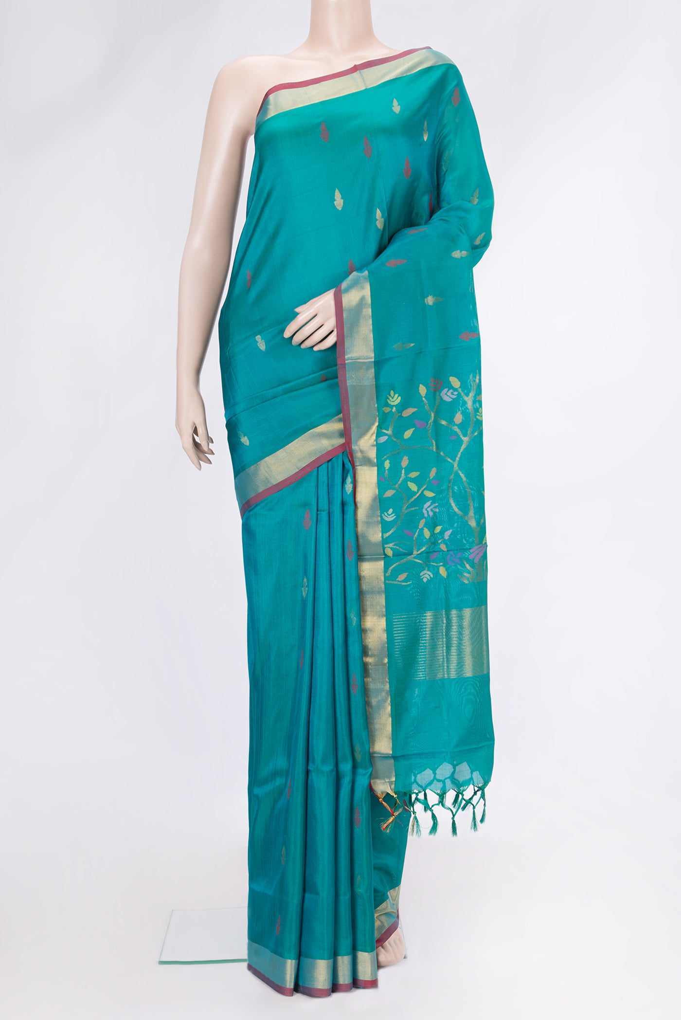 Sky Blue Dual Tone Uppada Silk Saree with Zari And Thread Butta on the body and Zari Border.  displayed on a mannequin