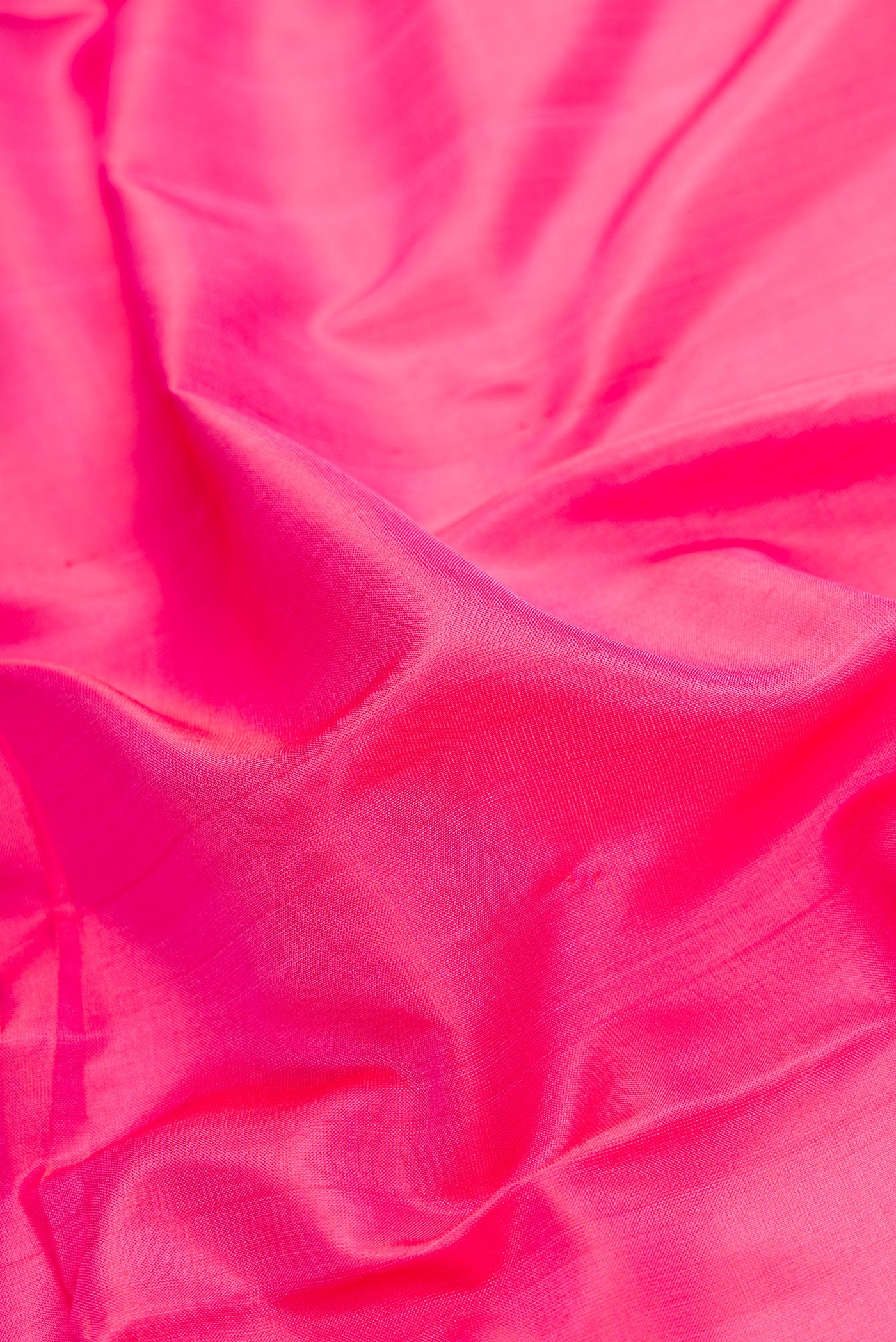 Close up of Pink Dual Tone Uppada Silk Saree with Plain Body and Zari Border.  displaying folds
